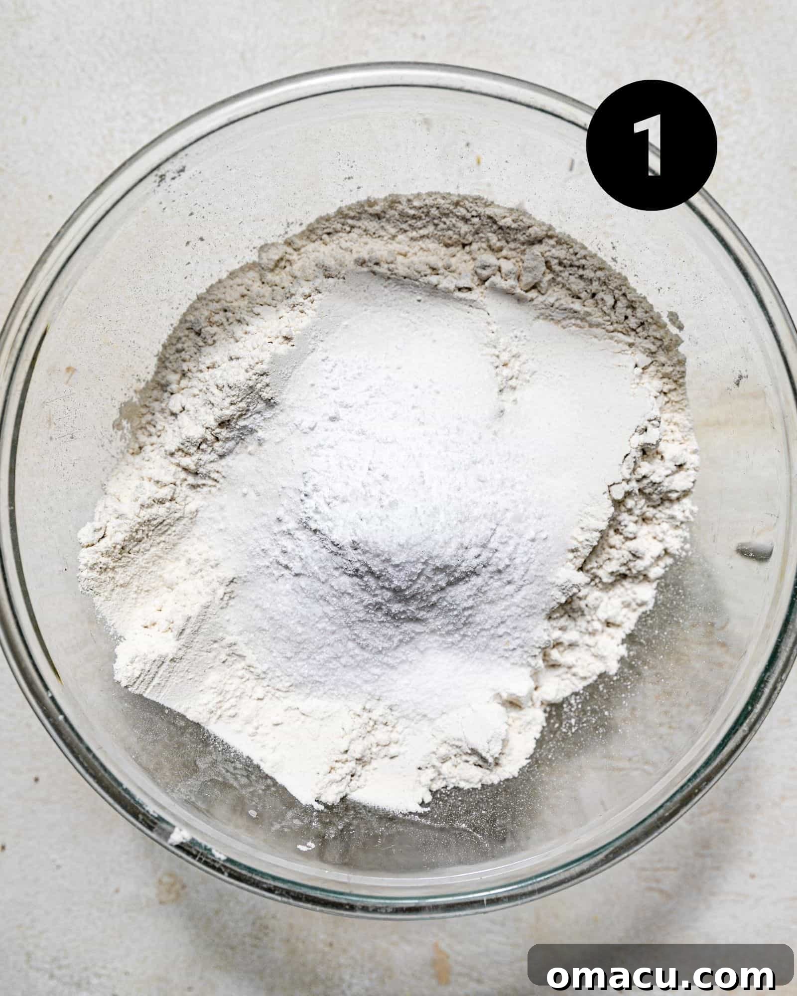 dry ingredients combined in a glass mixing bowl.