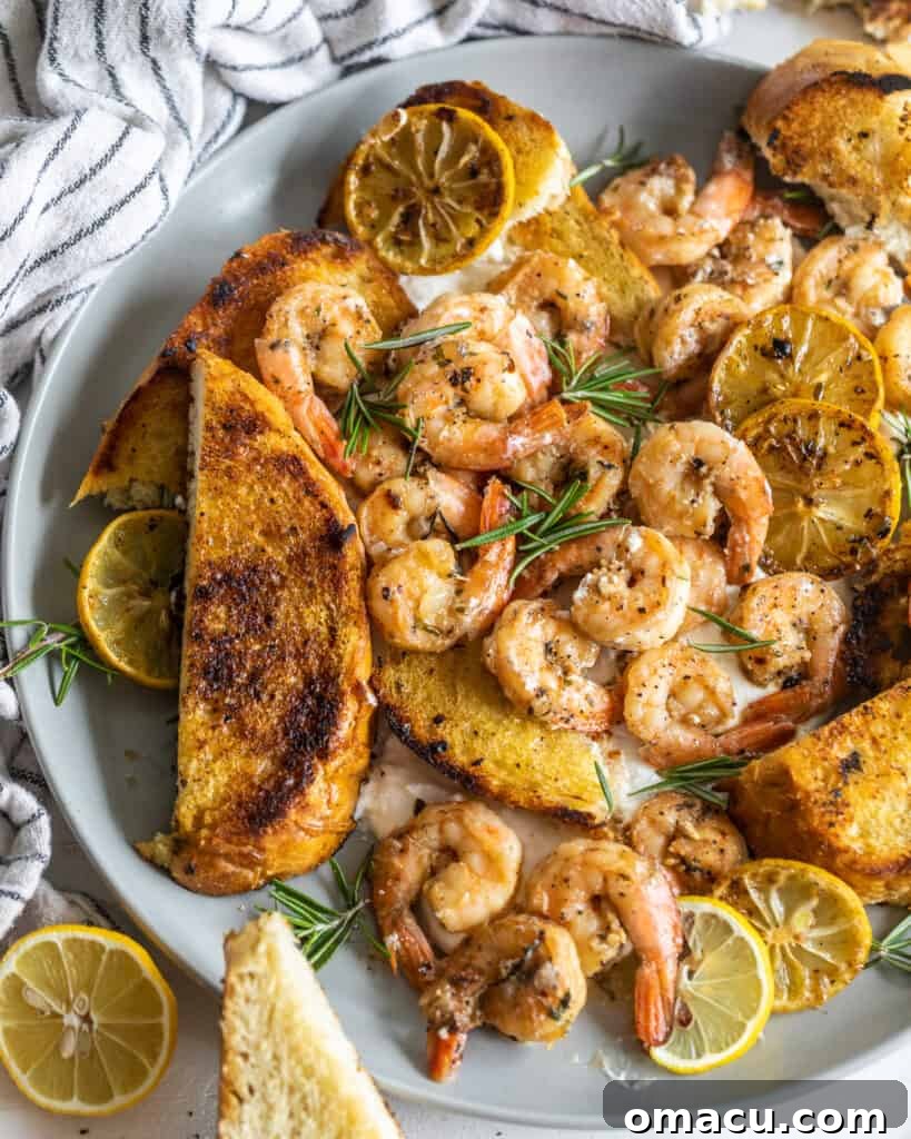 Shrimp and toast on a plate with fresh herbs and lemon