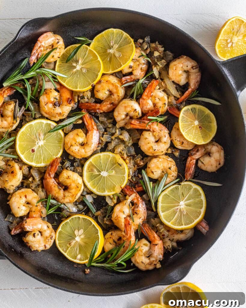Shrimp on a cast iron skillet with lemons and herbs