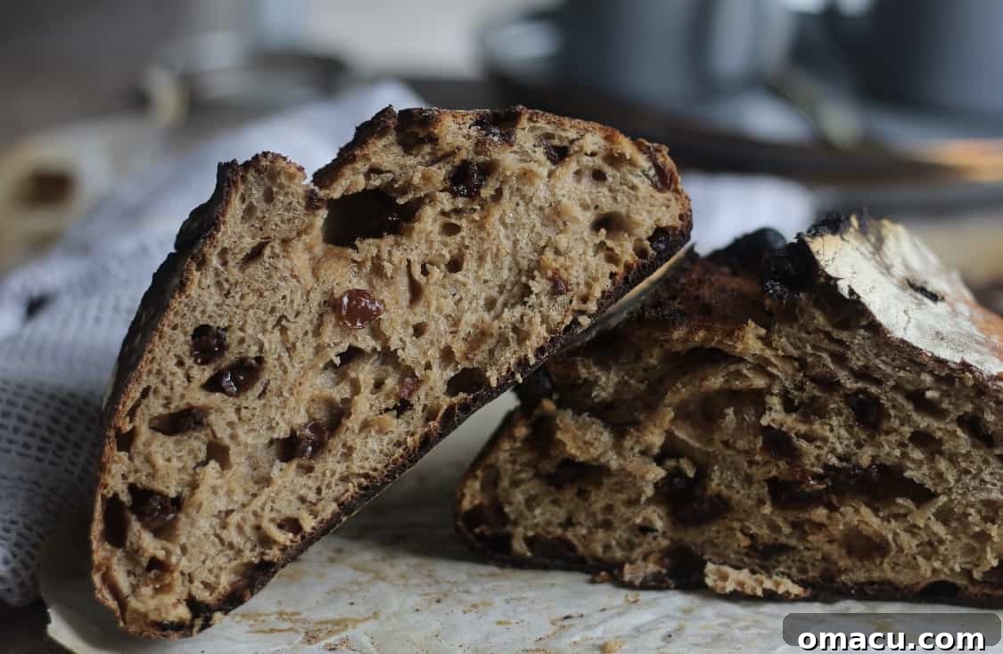 A close-up shot of a sliced cinnamon raisin sourdough loaf, showcasing its soft interior and caramelized crust.