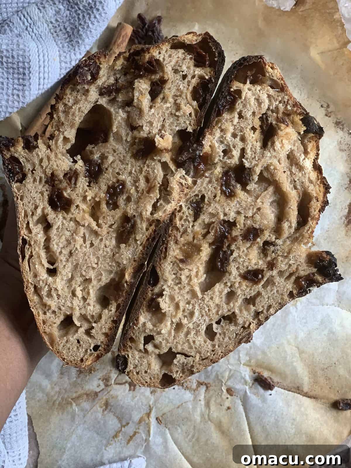 A freshly baked cinnamon raisin sourdough loaf cooling on a wire rack, steam gently rising.
