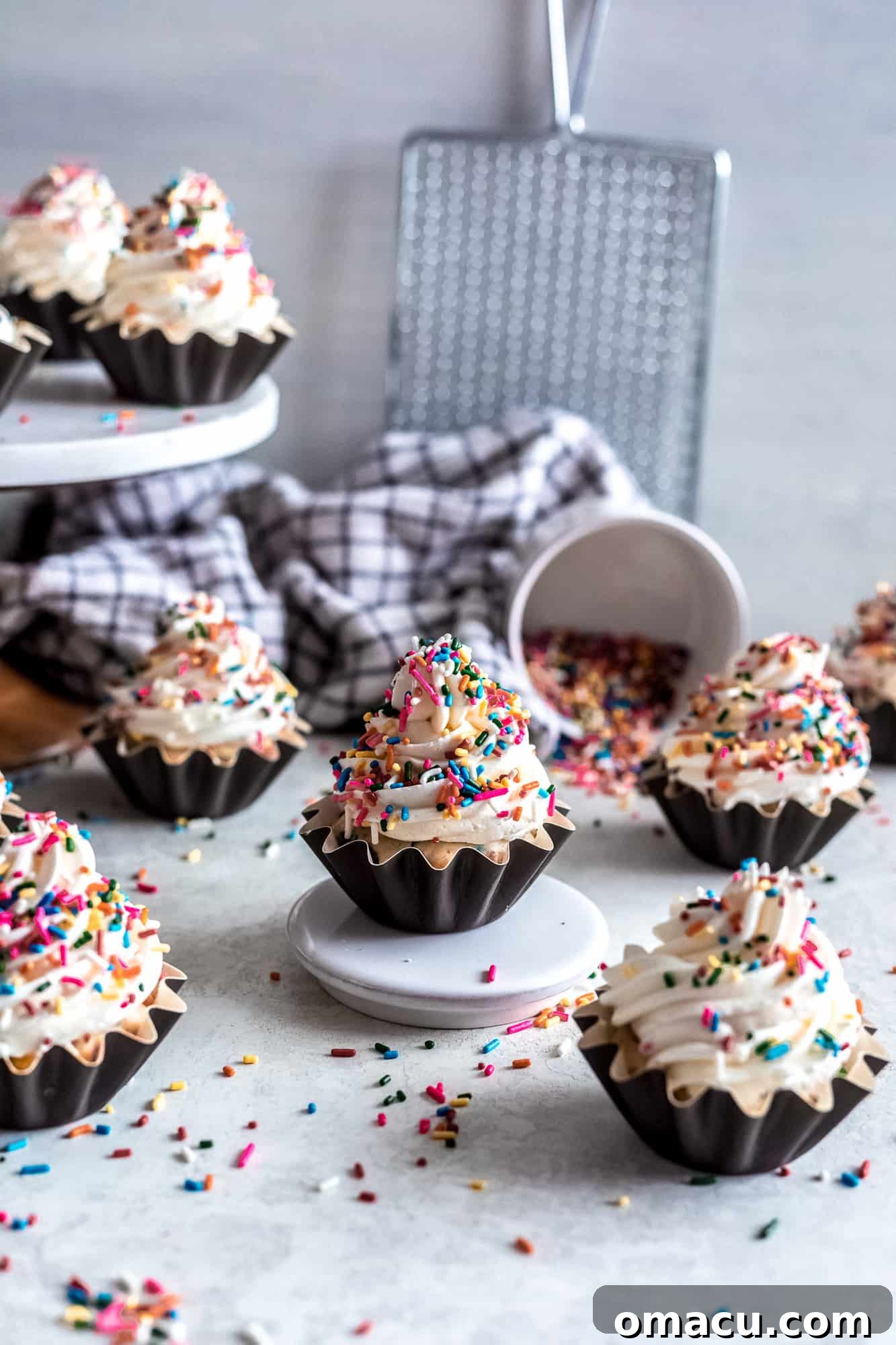 Vibrant Funfetti Cupcakes with Almond Buttercream and colorful sprinkles on a pristine white surface, ready to be enjoyed.