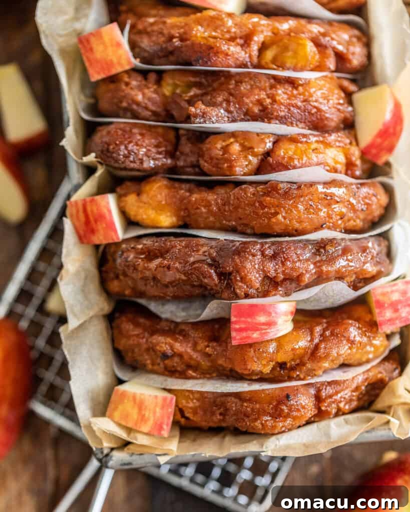 Up close overhead photo of a plate of golden brown apple pear fritters