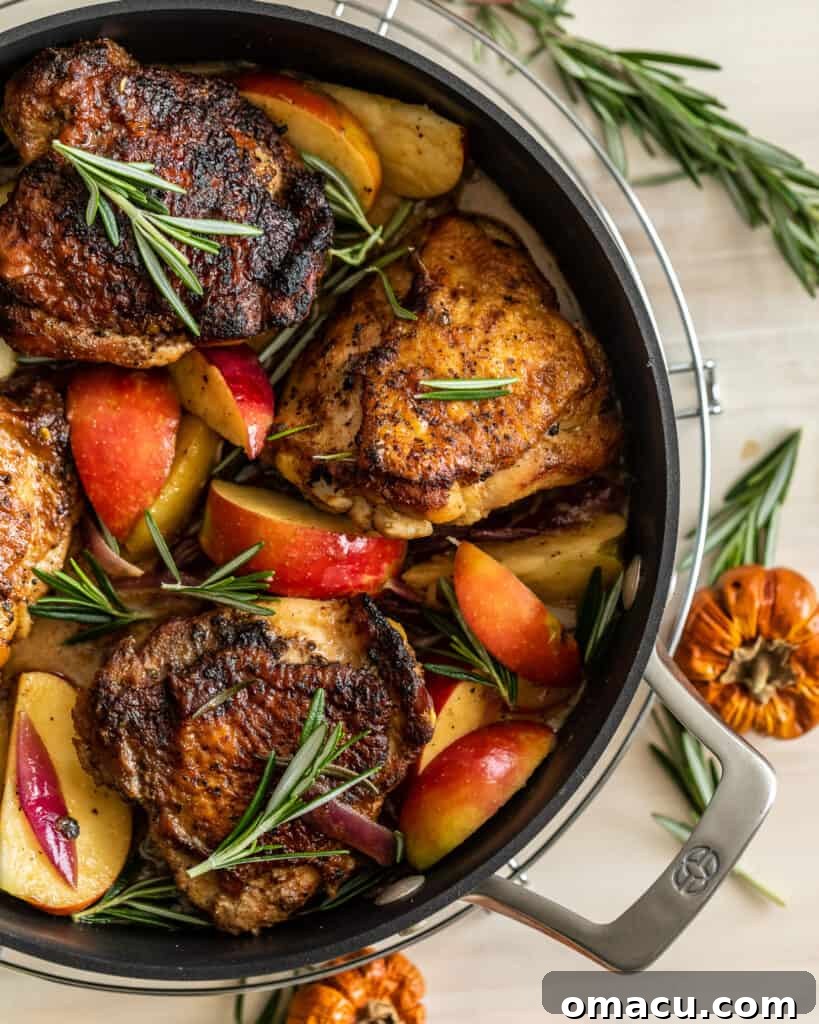 An inviting overhead view of the finished Rosemary Apple Cider Chicken, showcasing the crispy chicken, vibrant apples, and rich sauce.