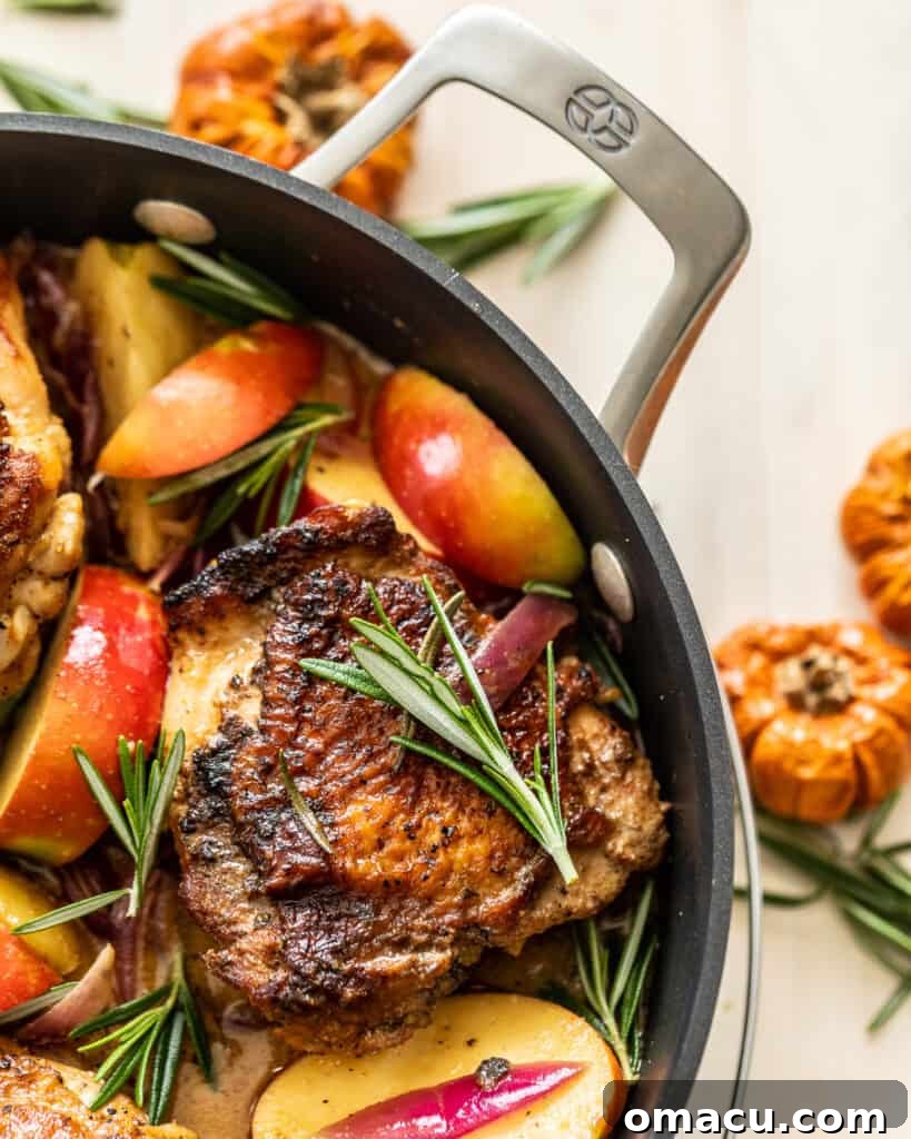 Rosemary Apple Cider Chicken presented in a gleaming Calphalon pan, highlighting the golden chicken and glossy sauce.