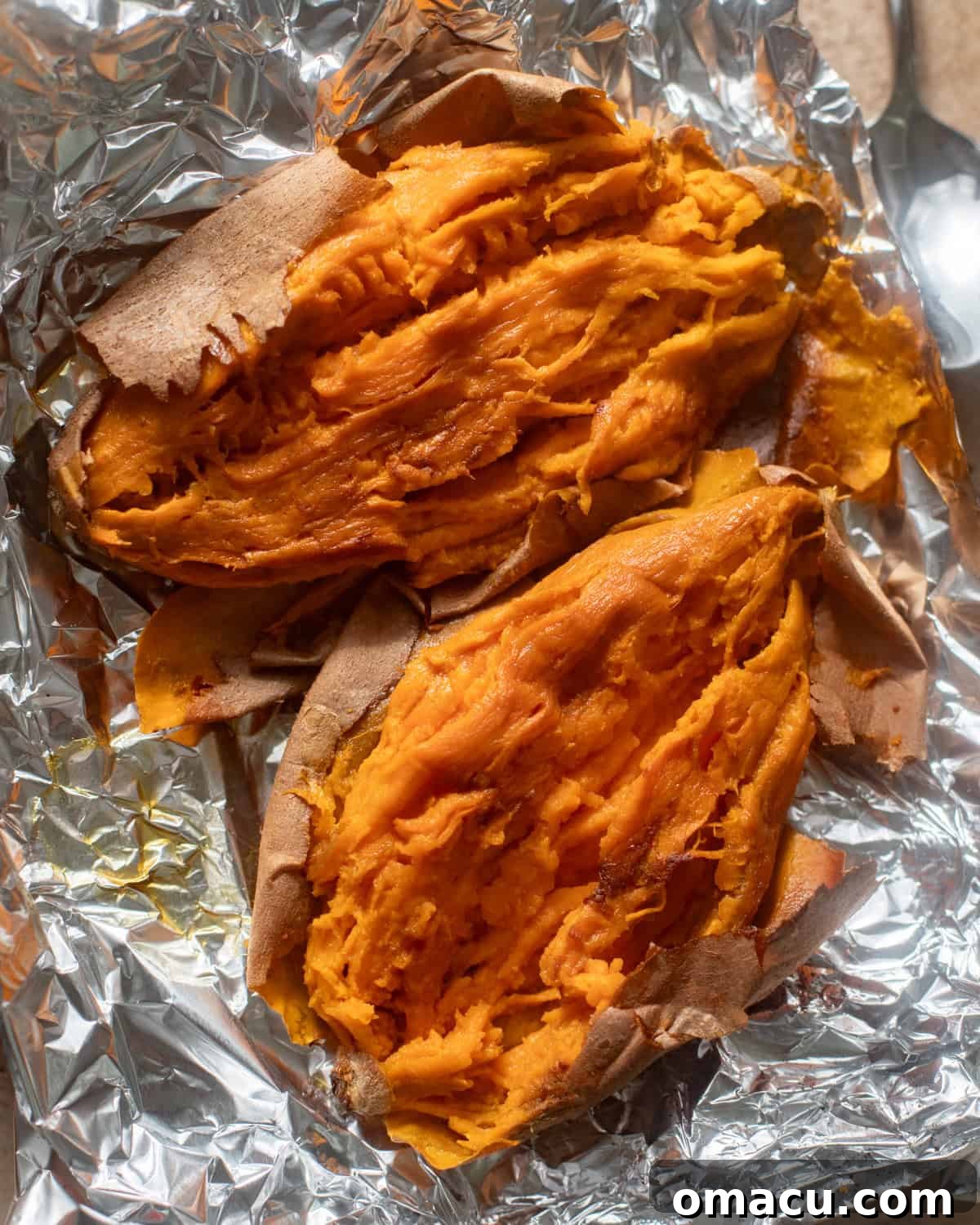 Roasted sweet potatoes, mashed on a piece of aluminum foil, ready for the filling mixture.
