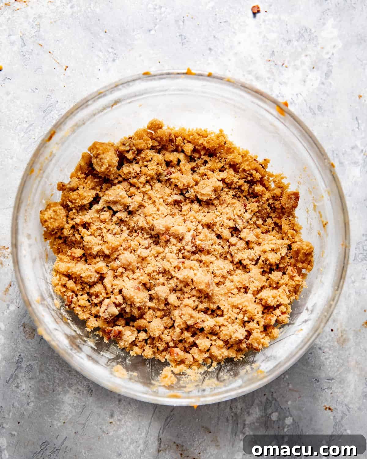 Pecan streusel mixture in a bowl, showing the crumbly texture before baking.
