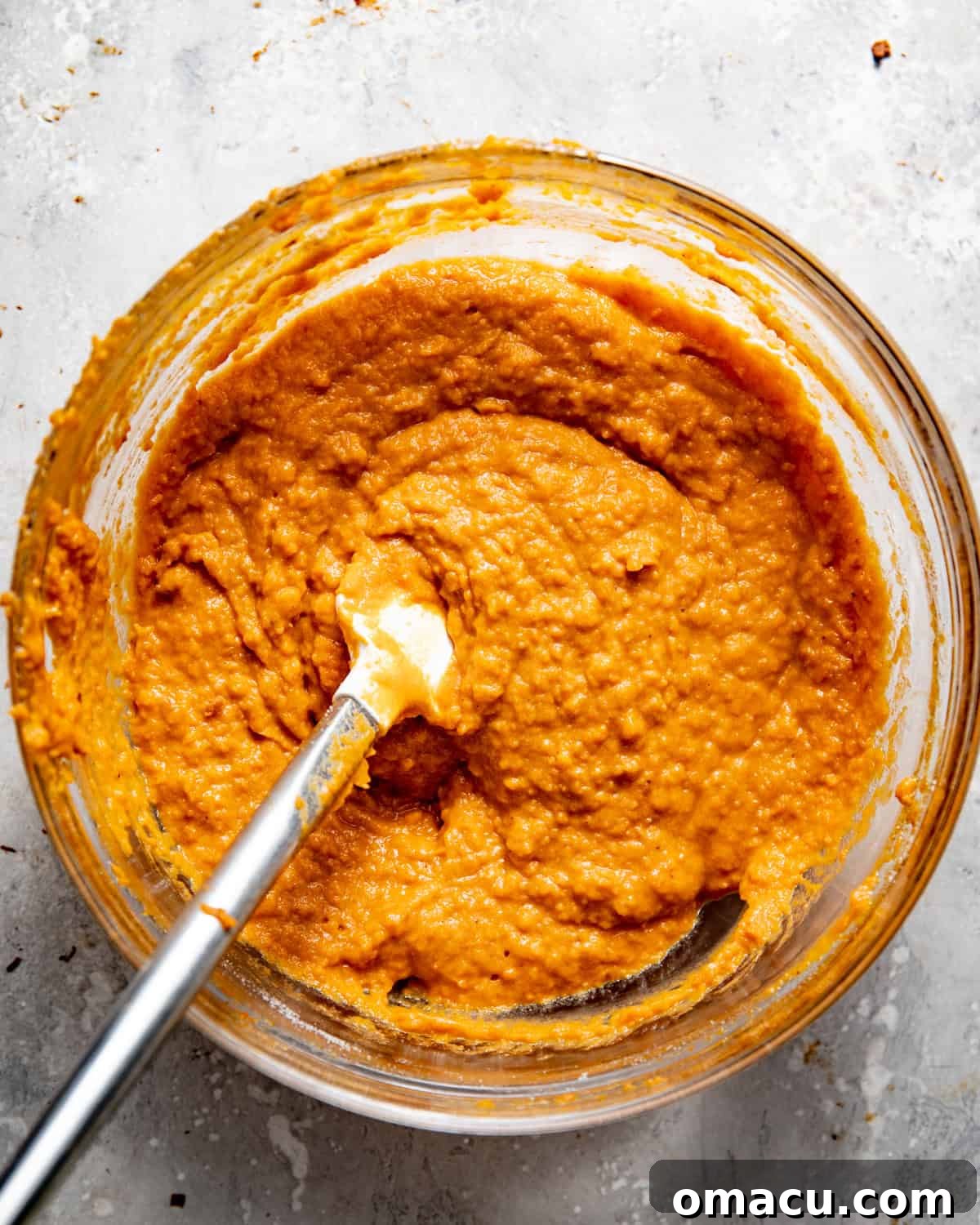 Creamy sweet potato filling mixture in a bowl, showing its smooth texture before being spread into the crust.