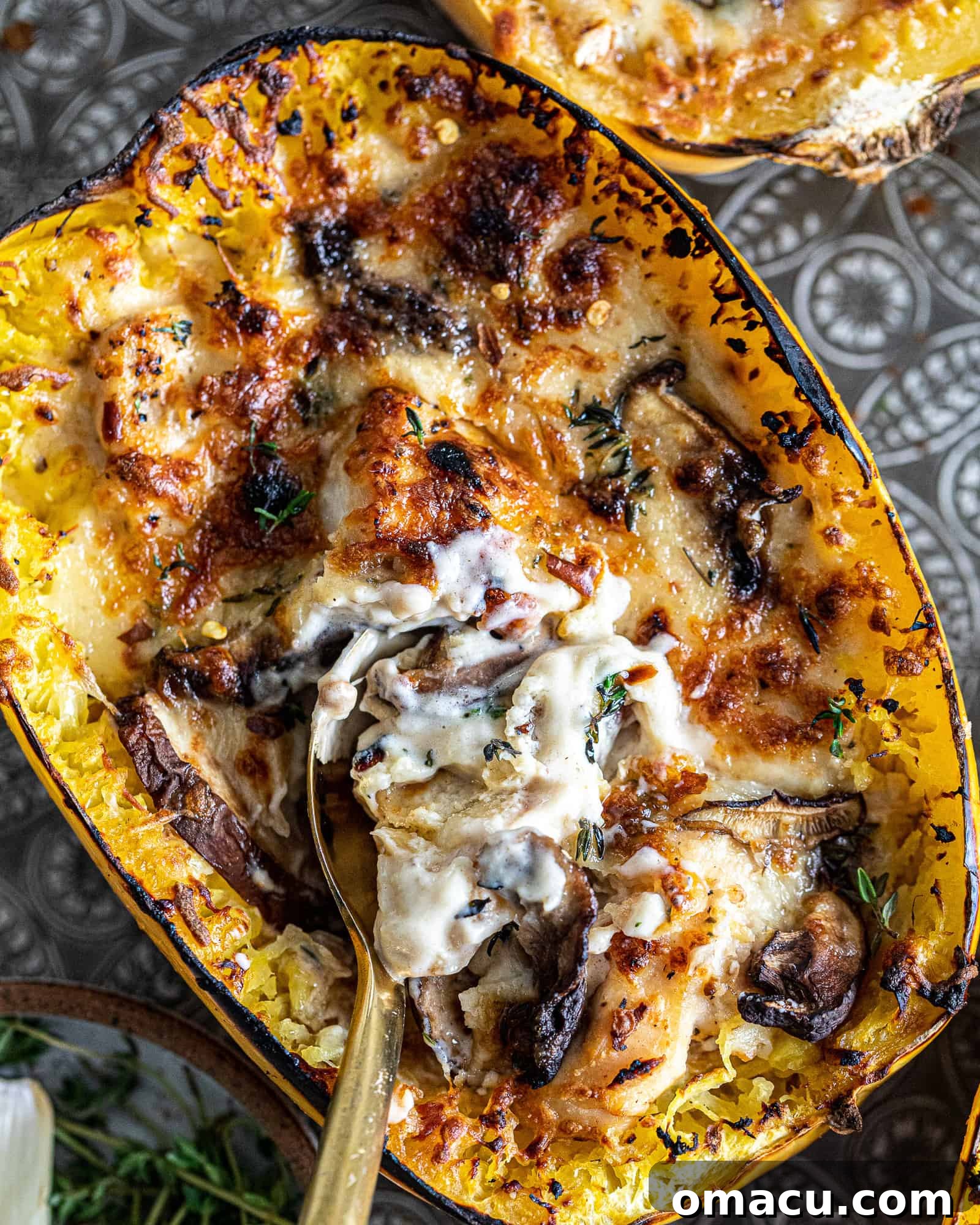 Close-up view of the golden-brown, roasted spaghetti squash, showing its delicate strands and infused garlic flavor.