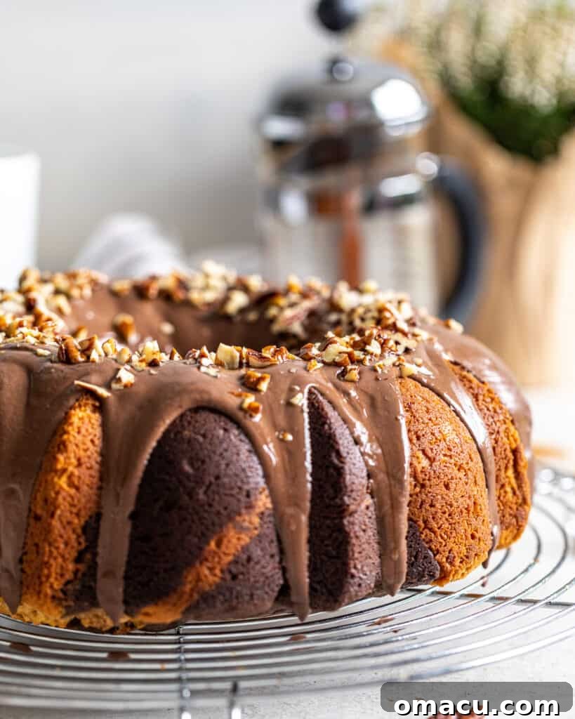 A close-up view of a slice of chocolate coffee marble cake, showcasing the beautiful marbling pattern of light vanilla and dark coffee-chocolate batters.