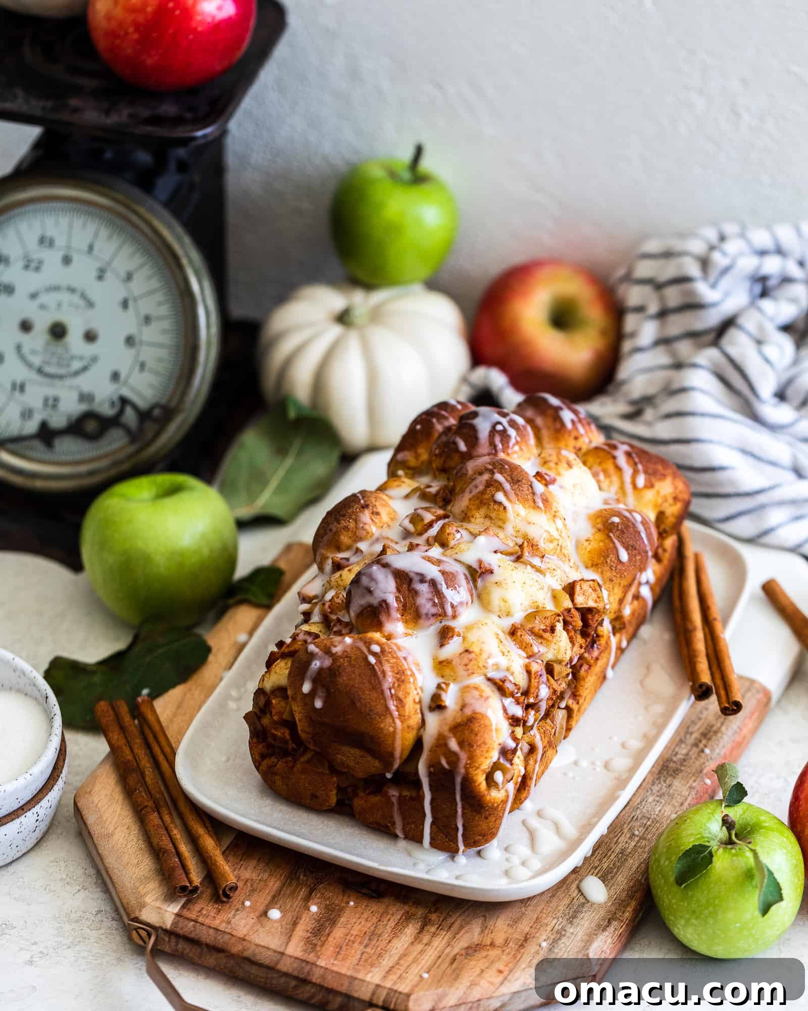 Freshly baked Apple and Pear Bread loaf with apples and a pumpkin in a rustic autumn setting