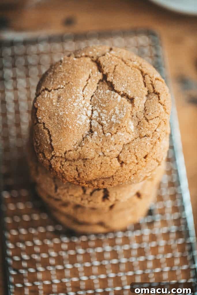 A stack of golden-brown brown butter chai cookies on a unique potato grater, suggesting homemade warmth