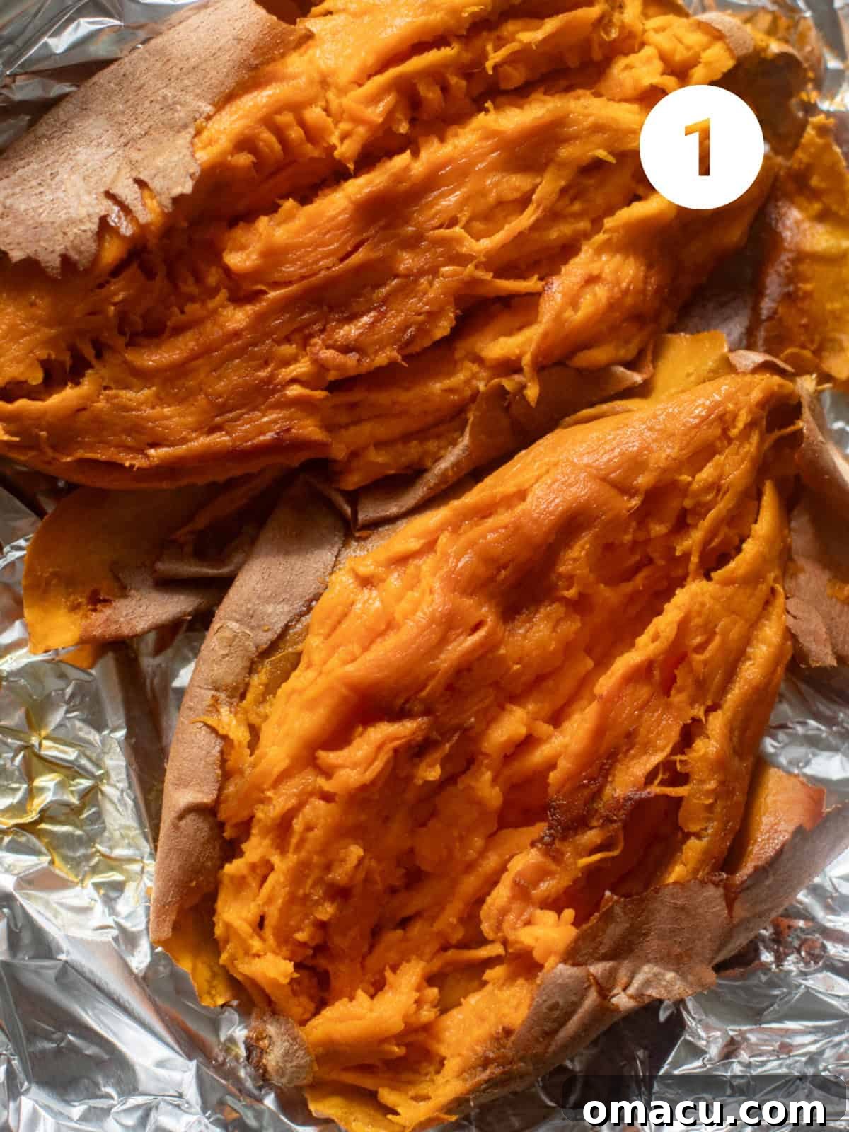 Roasted and mashed sweet potatoes on aluminum foil, cooling and ready for mixing into the pound cake batter.