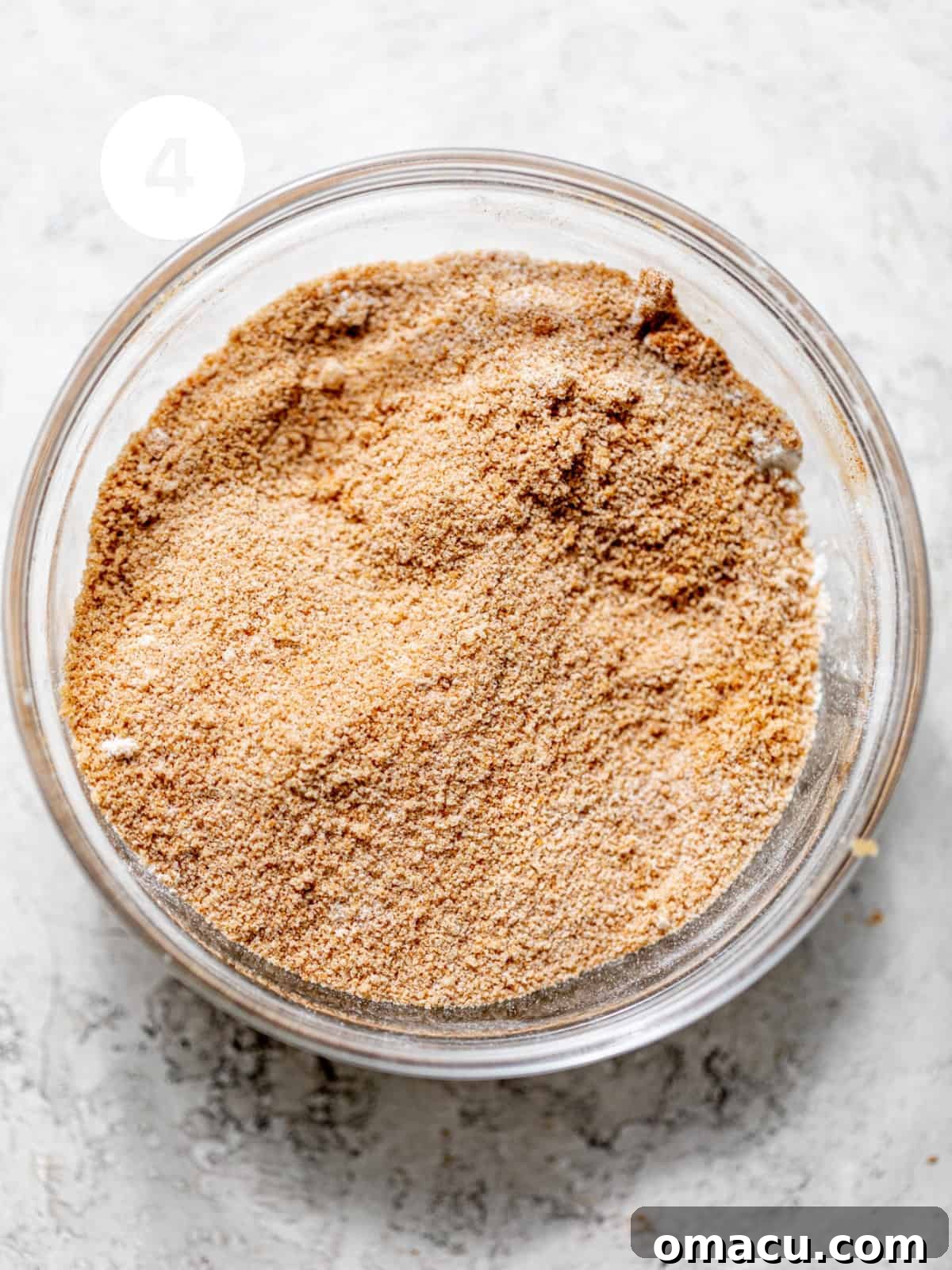 Cinnamon sugar filling perfectly whisked together in a bowl, ready to create a delicious swirl in the cake.