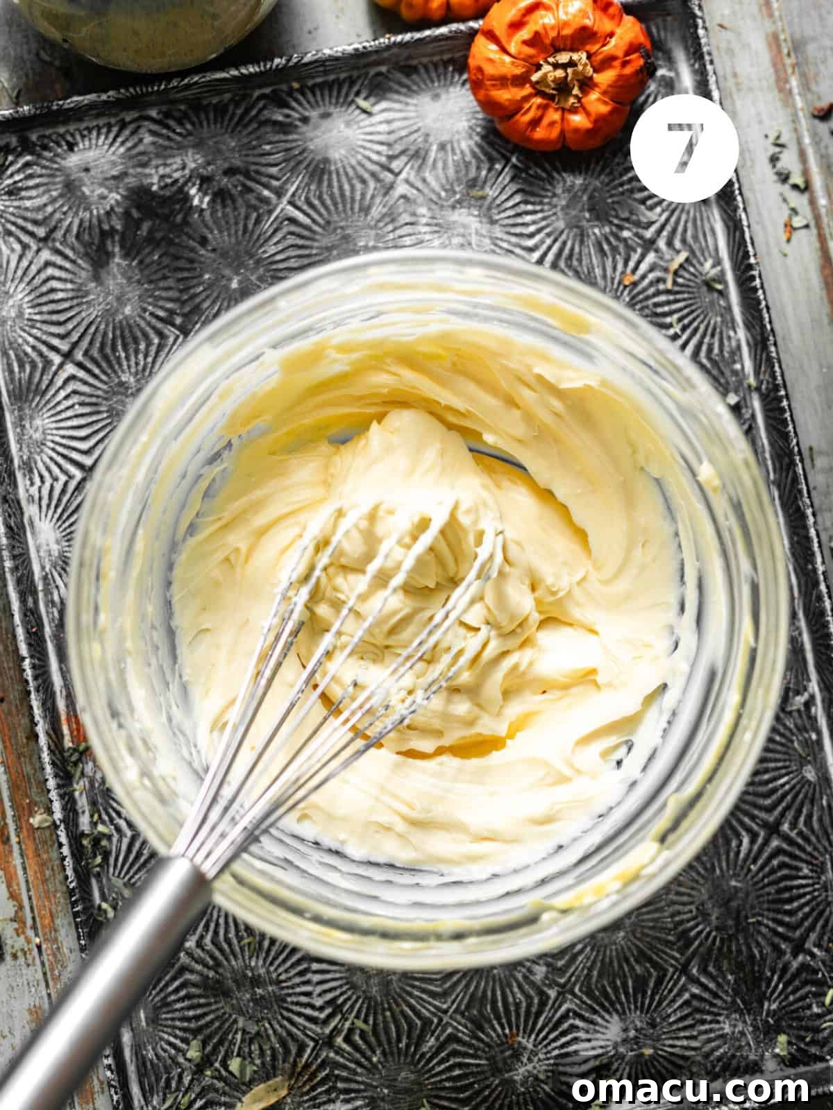 Smooth and creamy cream cheese frosting, perfectly whisked together in a bowl, awaiting its final application.