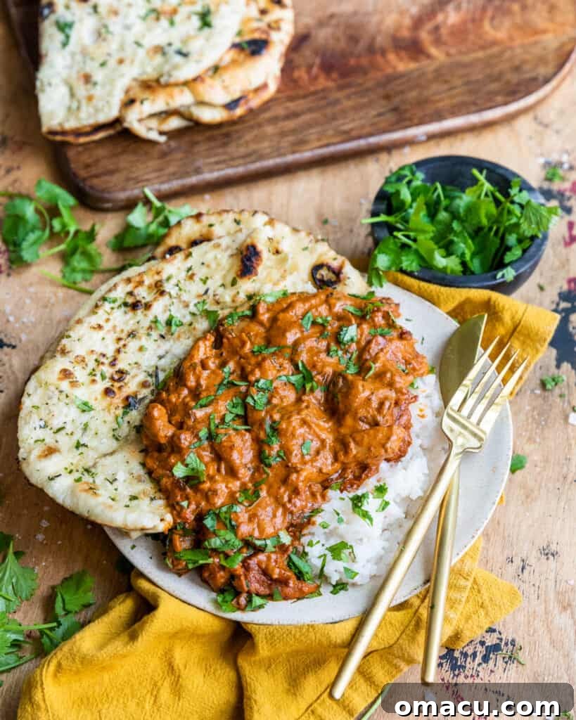 Delicious chicken and rice on a plate with fresh naan bread, ready to be served