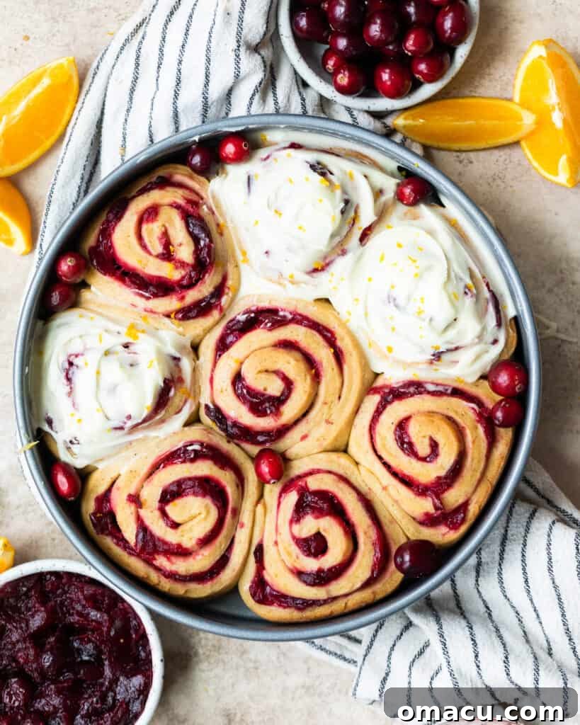 Freshly baked Cranberry Cinnamon Rolls arranged beautifully on a serving dish, ready to be glazed.