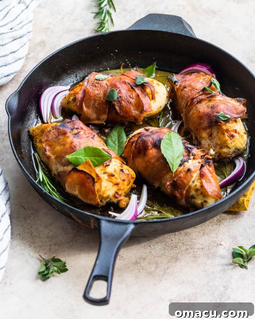 Close-up of a single piece of prosciutto wrapped chicken with melted blue cheese inside
