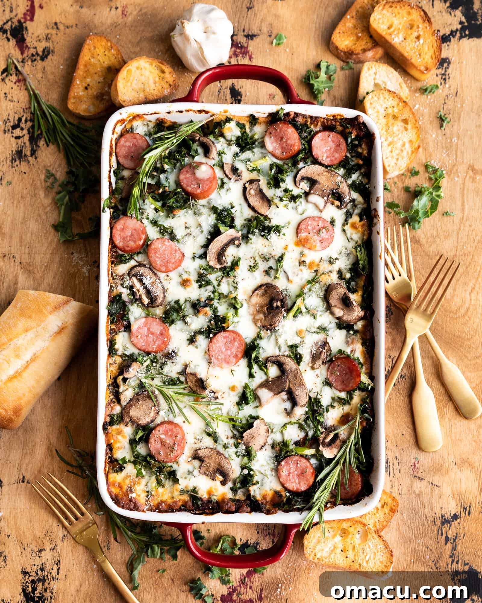 An inviting overhead photo of the Roasted Garlic Sausage Kale and Mushroom Lasagna in a baking dish, ready to be served.
