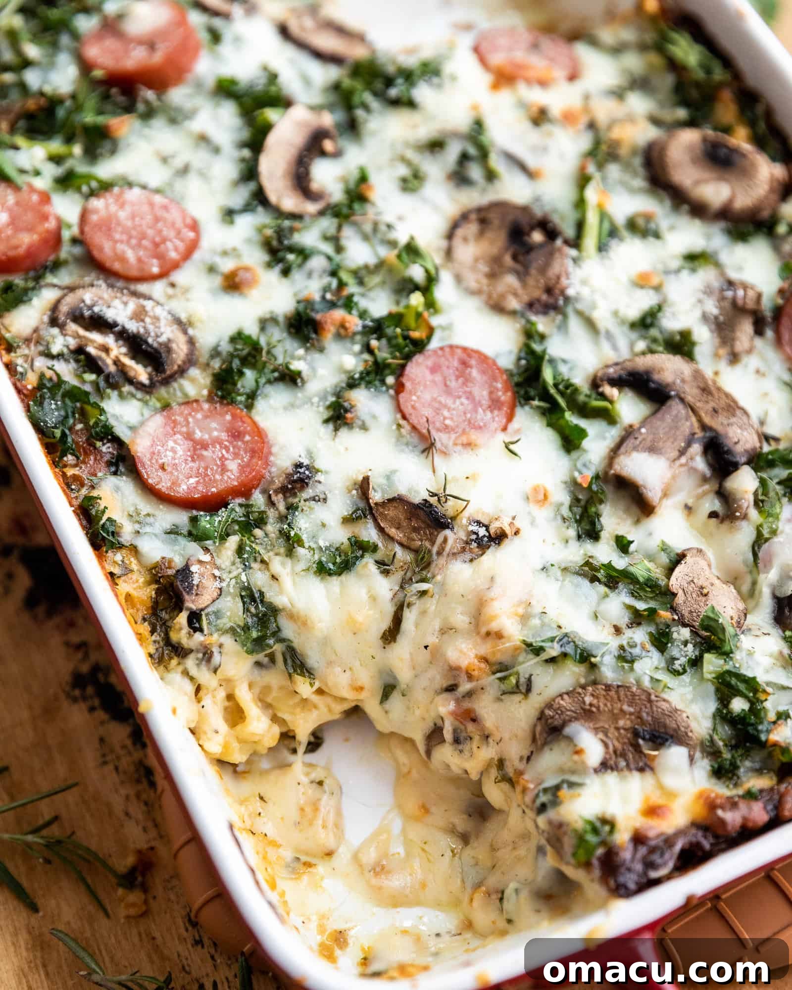 A close-up view of the golden-brown, cheesy top of the baked Roasted Garlic Sausage Kale and Mushroom Lasagna, fresh out of the oven.