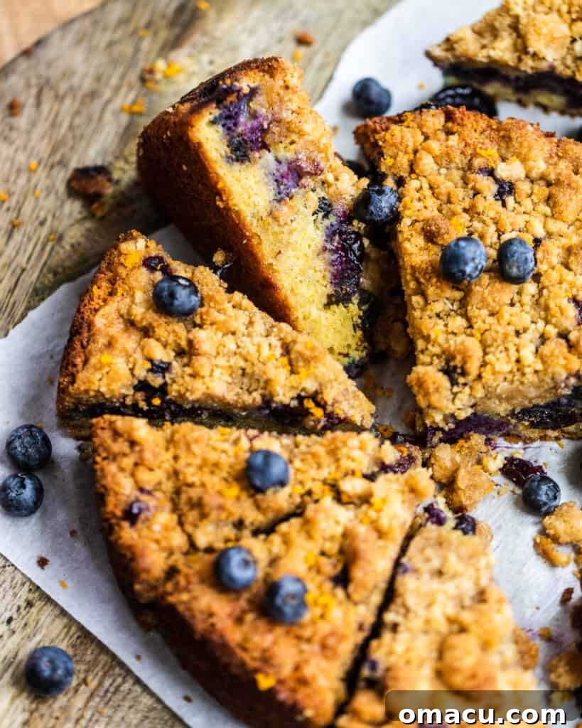 a close-up of a sliced blueberry prune buckle on a piece of parchment paper