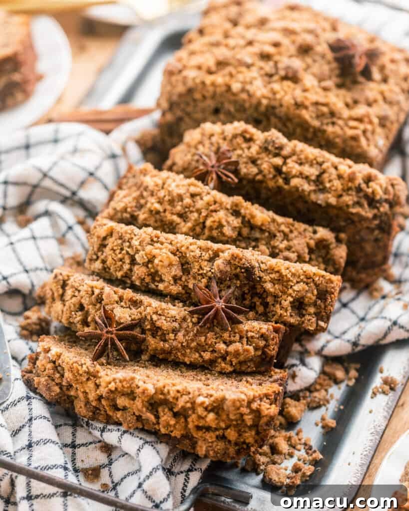 A beautifully sliced loaf of maple cinnamon banana bread, garnished with star anise for an elegant touch
