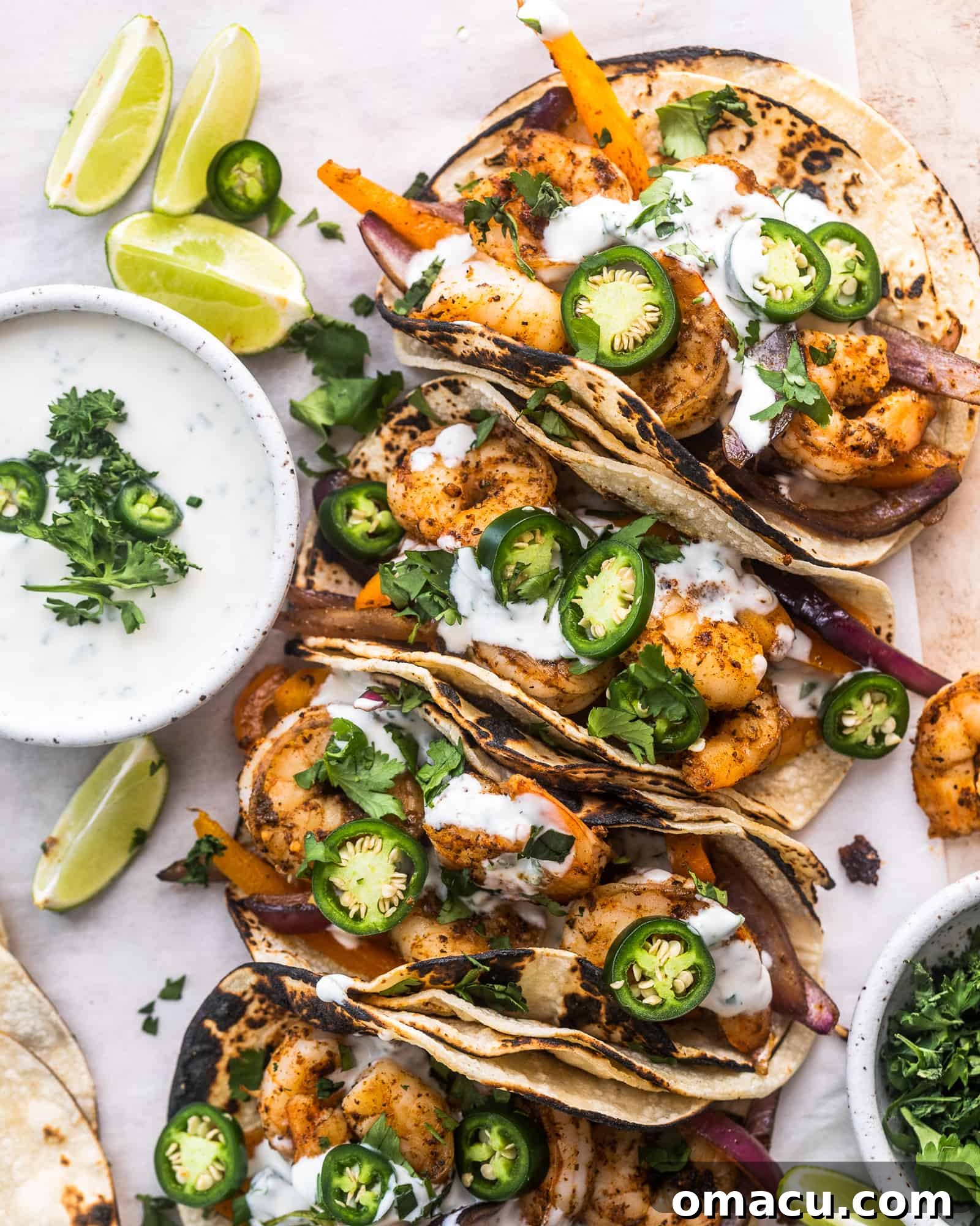 cajun shrimp tacos on parchment paper with ranch sauce, ready to serve