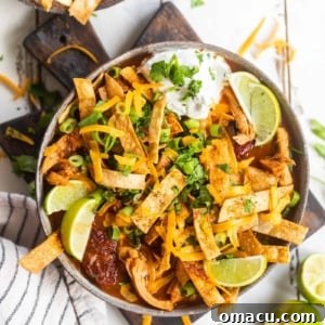 spicy chicken tortilla soup with lime on a cutting board