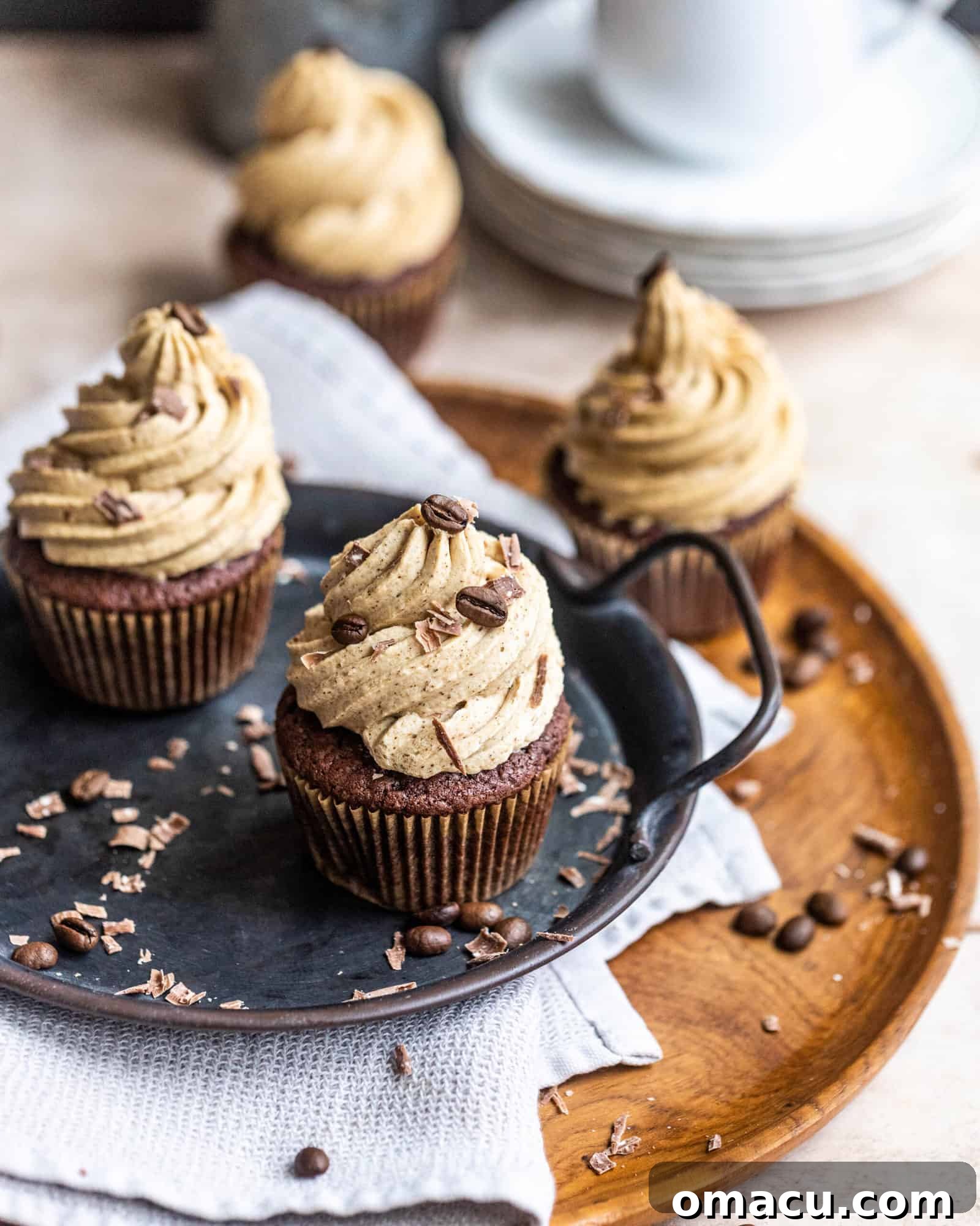 cupcakes on a wooden plate, showing the delicate frosting