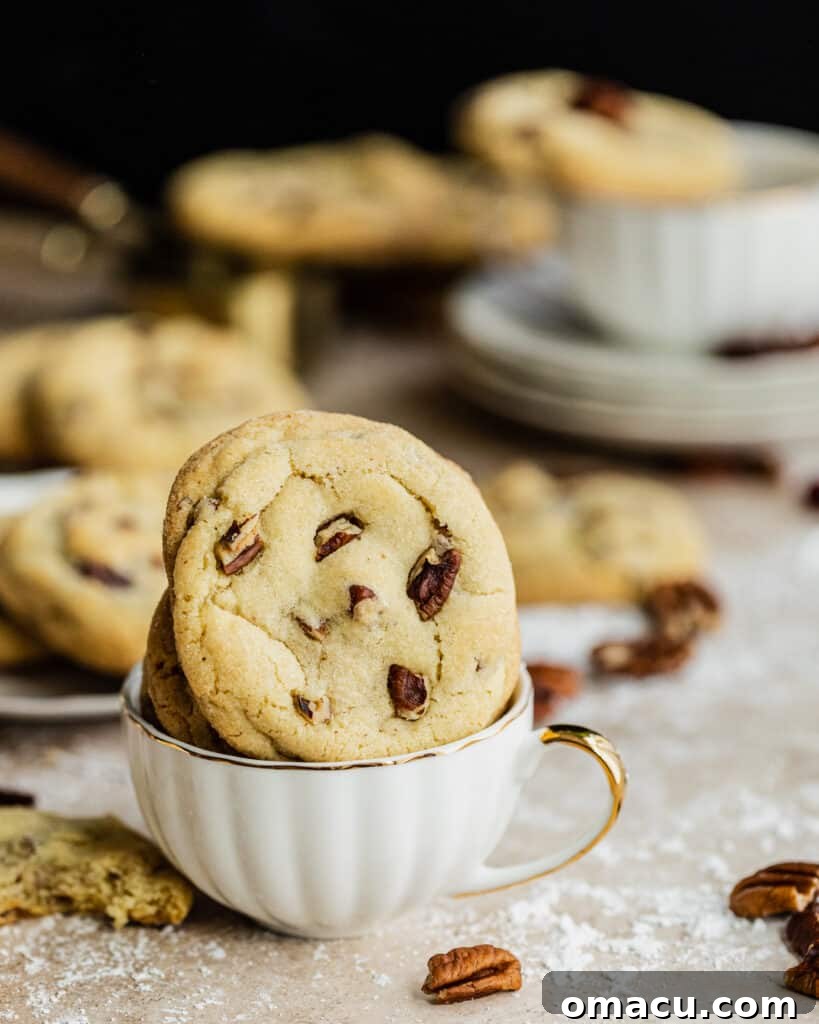 A charming cookie nestled in a teacup, beautifully arranged for a cozy food photography scene.