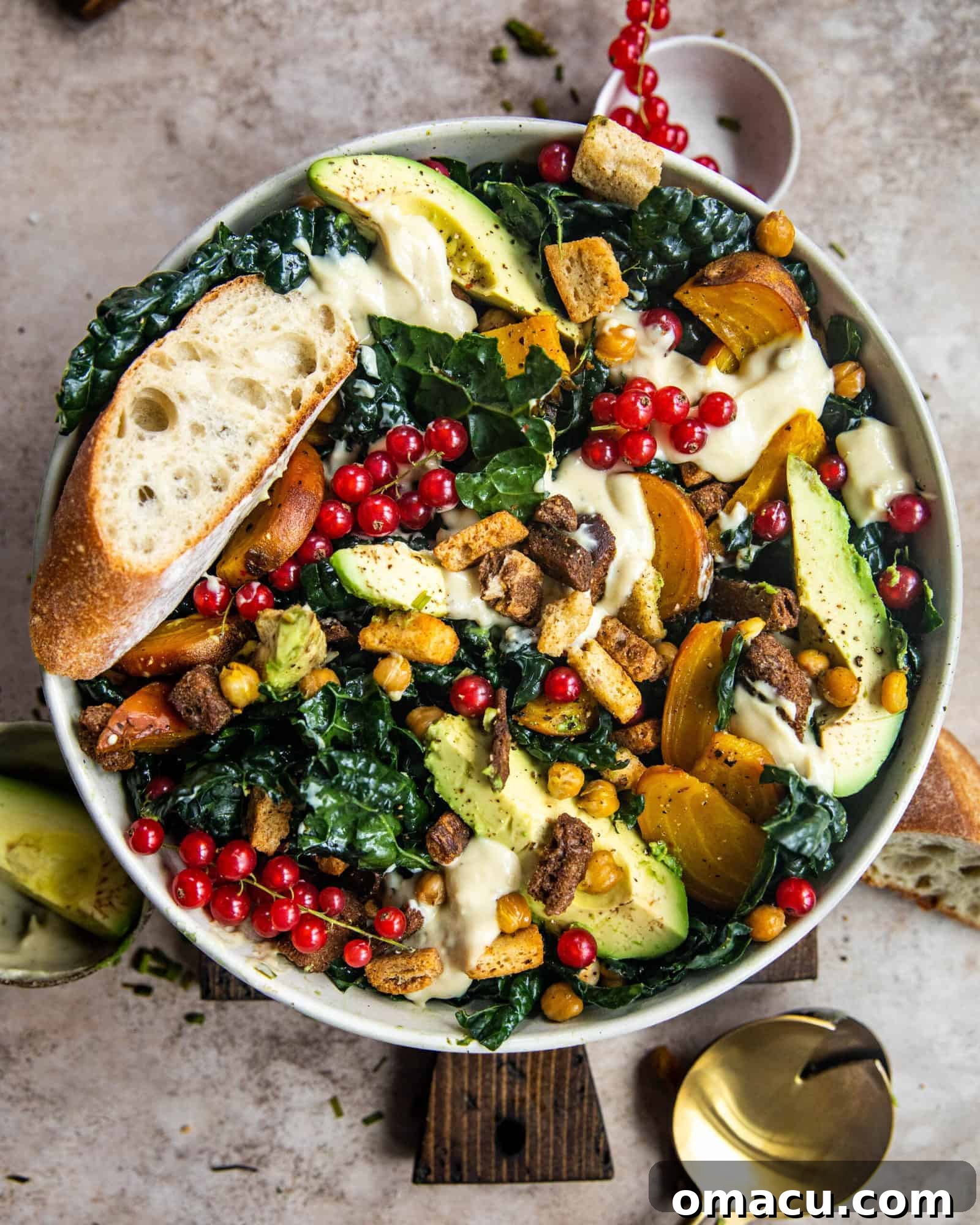 Delicious vegan kale caesar salad in a rustic bowl, accompanied by slices of fresh bread, highlighting its vibrant ingredients and inviting presentation.