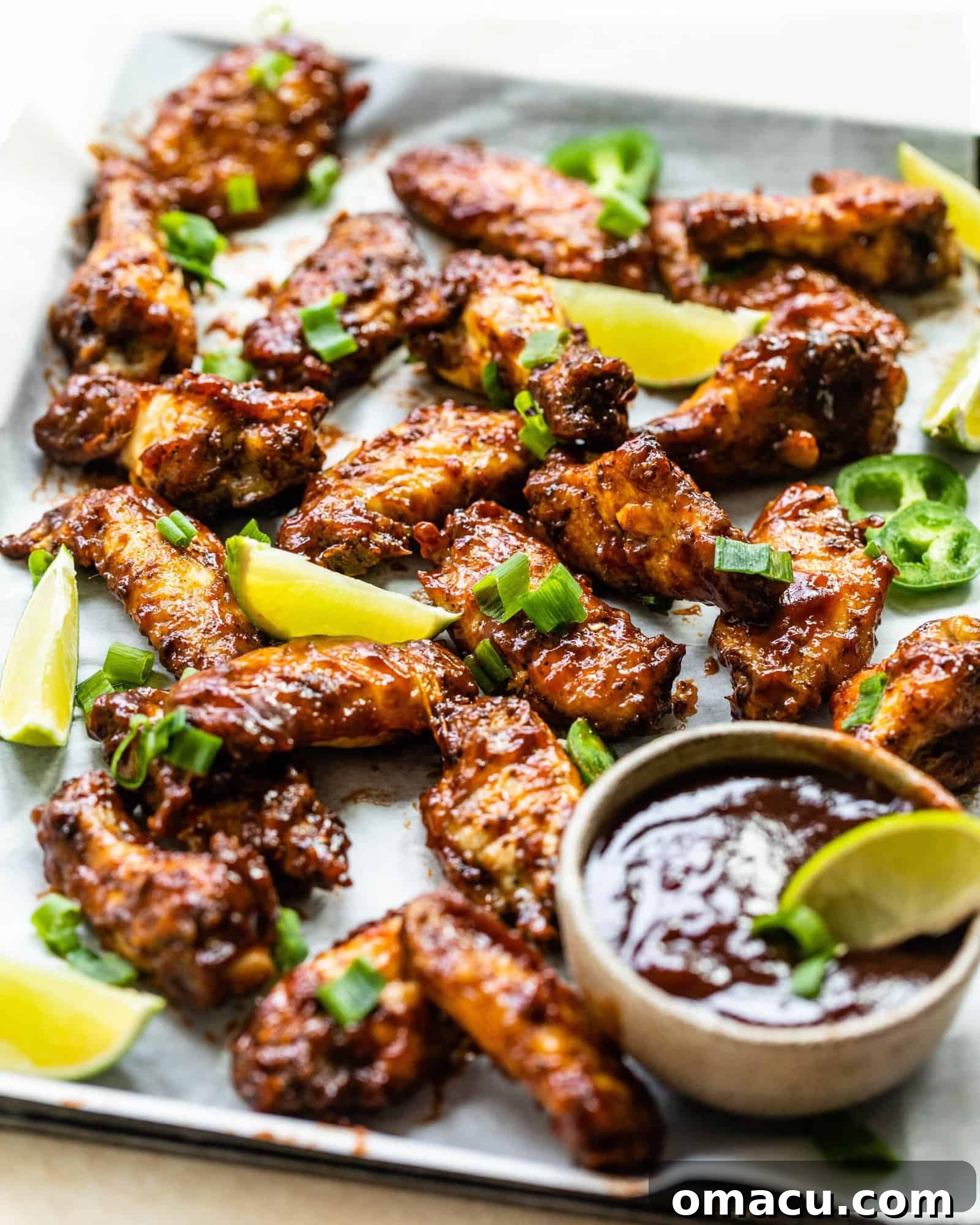 A vibrant close-up of Cajun BBQ wings, showcasing the crispy texture and glistening BBQ sauce.