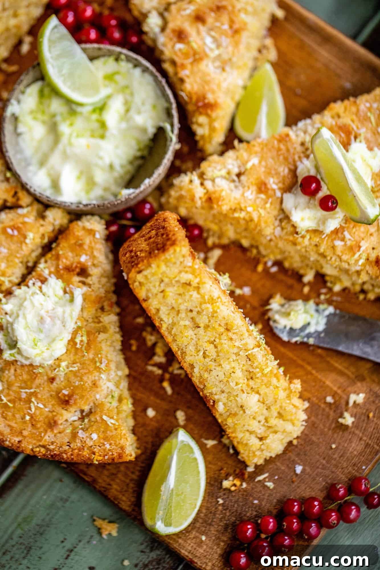 Creamy sweet lime butter presented in a rustic bowl next to perfectly golden slices of freshly baked coconut cornbread, highlighting their harmonious pairing.