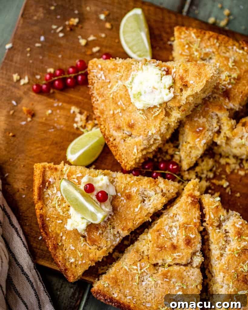 Vibrant green limes artfully arranged beside golden slices of fresh coconut cornbread on a warm wooden surface, emphasizing freshness and flavor.