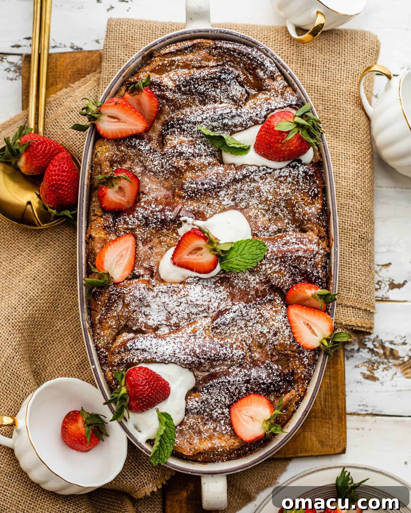 Close-up of the delicious Strawberry French Toast Casserole, showing the golden-brown crust and a peek of the sweet interior.