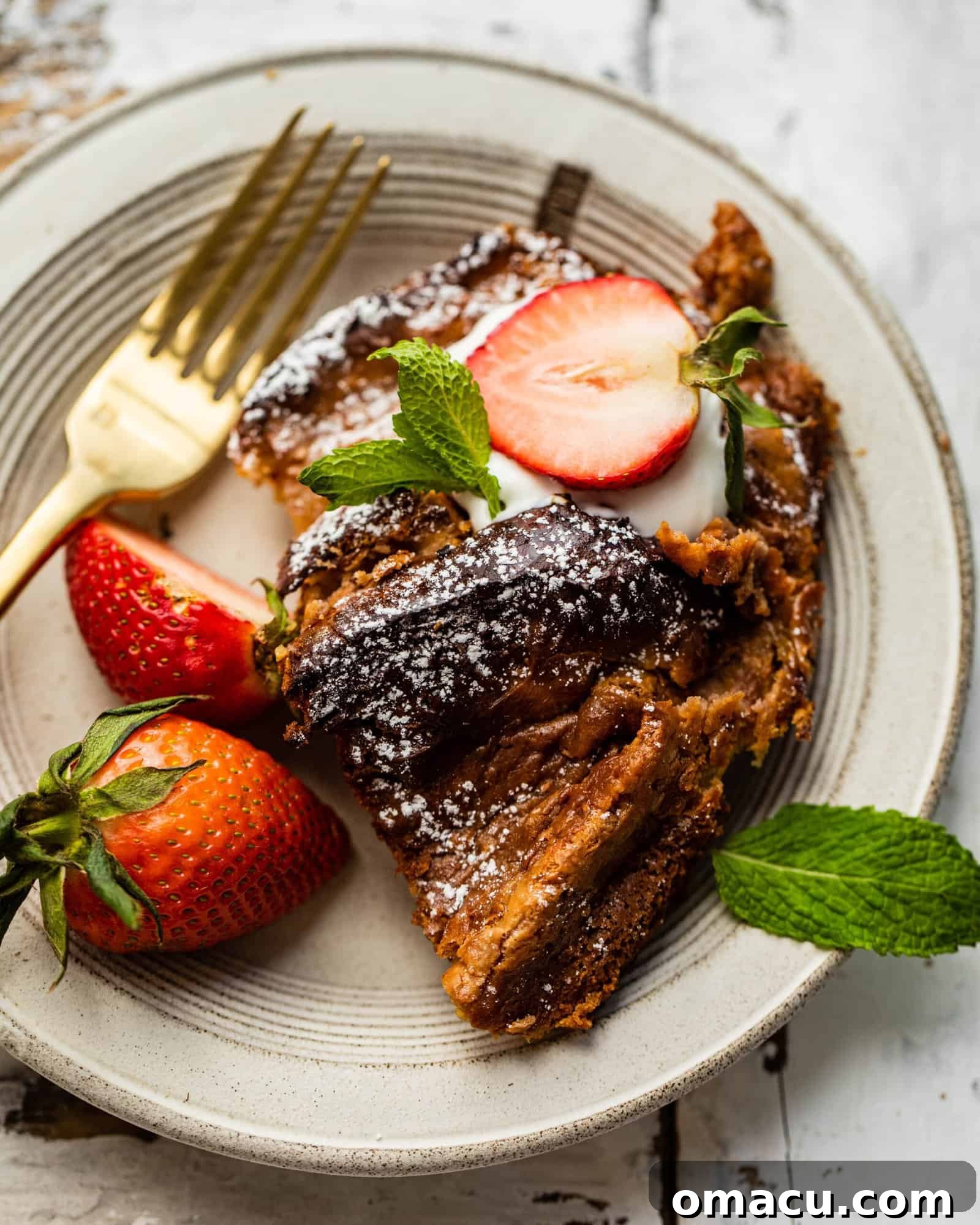 Another enticing shot of a sliced Strawberry French Toast Casserole piece on a plate, ready to be devoured.