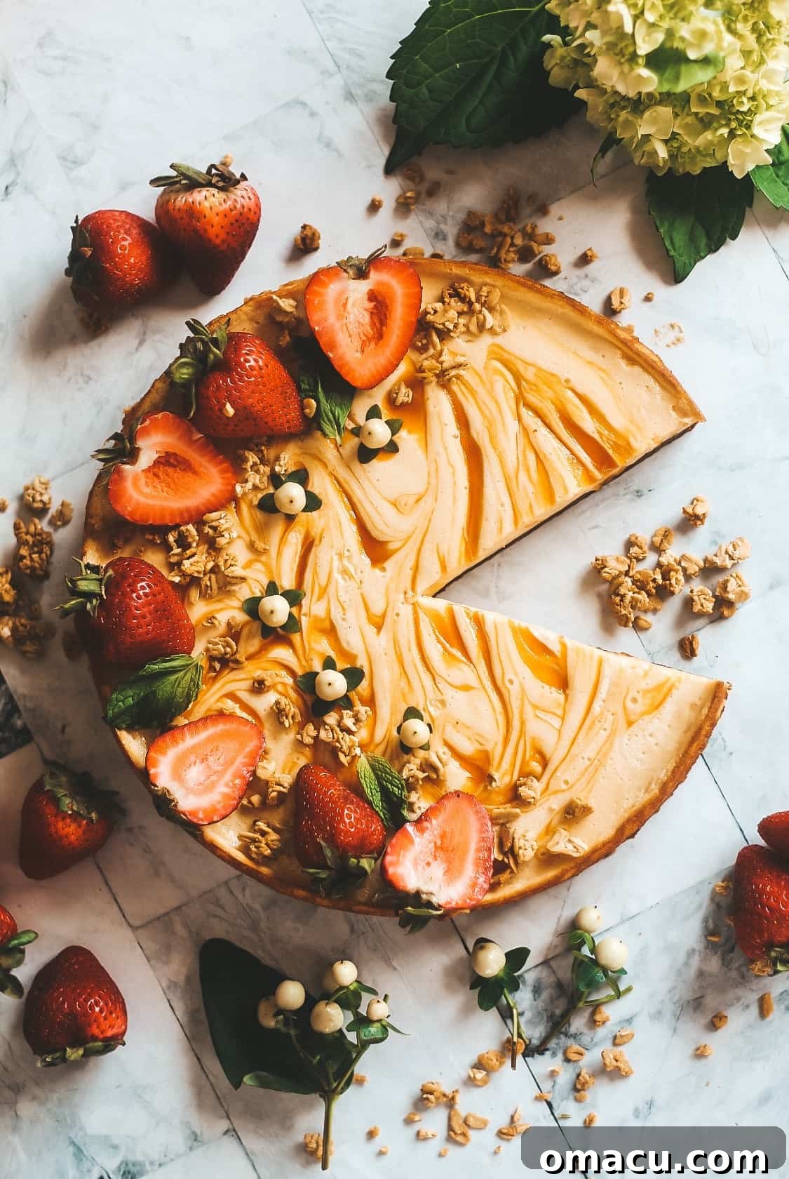 A beautifully decorated Apricot Cream Tart with fresh apricots and mint, showcasing the vibrant swirls of apricot jam.