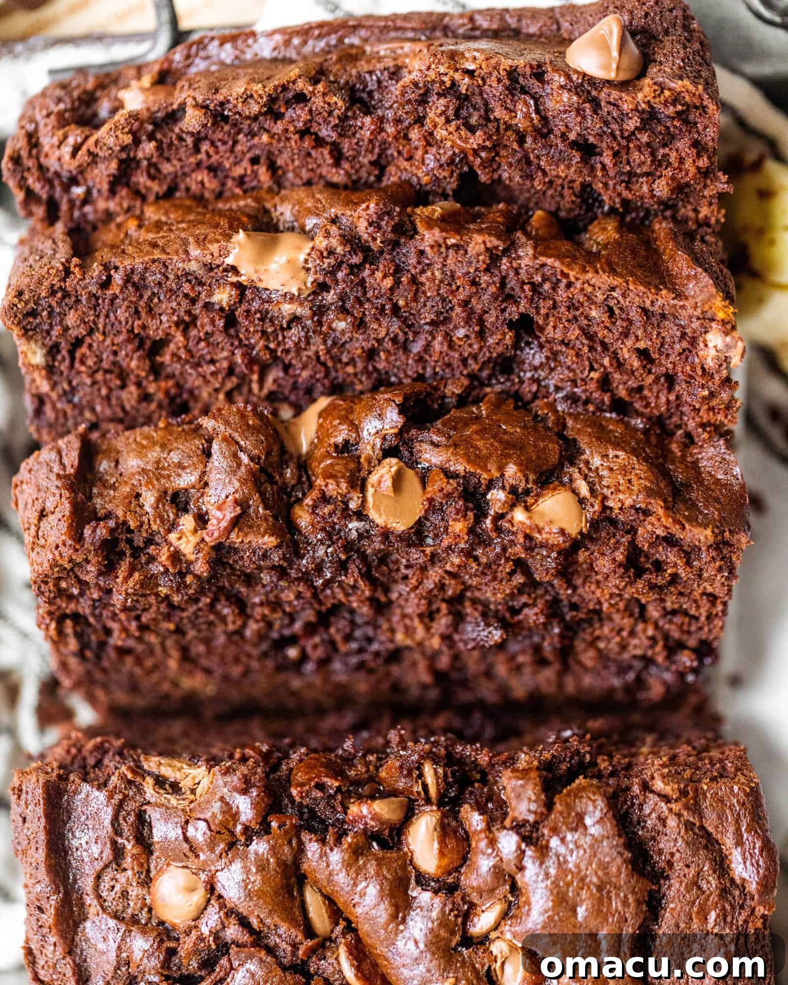 A top-down view of the whole chocolate banana bread loaf, showcasing its deep brown color and golden-brown crust, ready for slicing.