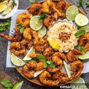 fried Coconut Shrimp on a plate with a sweet dipping sauce in a bowl
