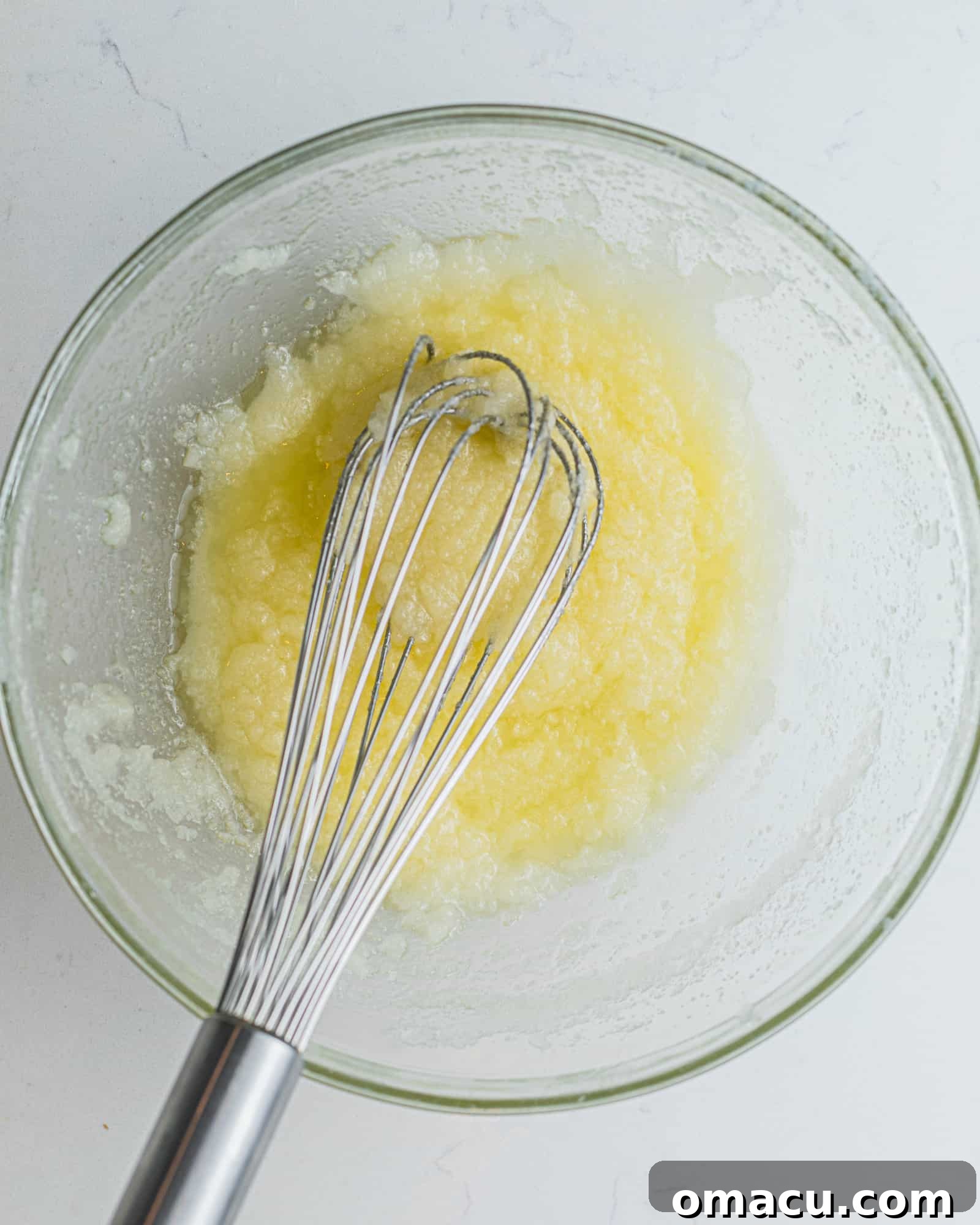 butter, oil, and sugar in a bowl with a whisk
