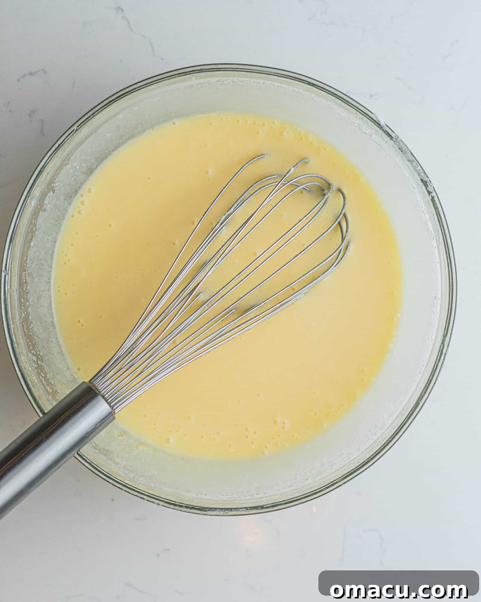all of the wet ingredients mixed together to form a smooth cupcake batter