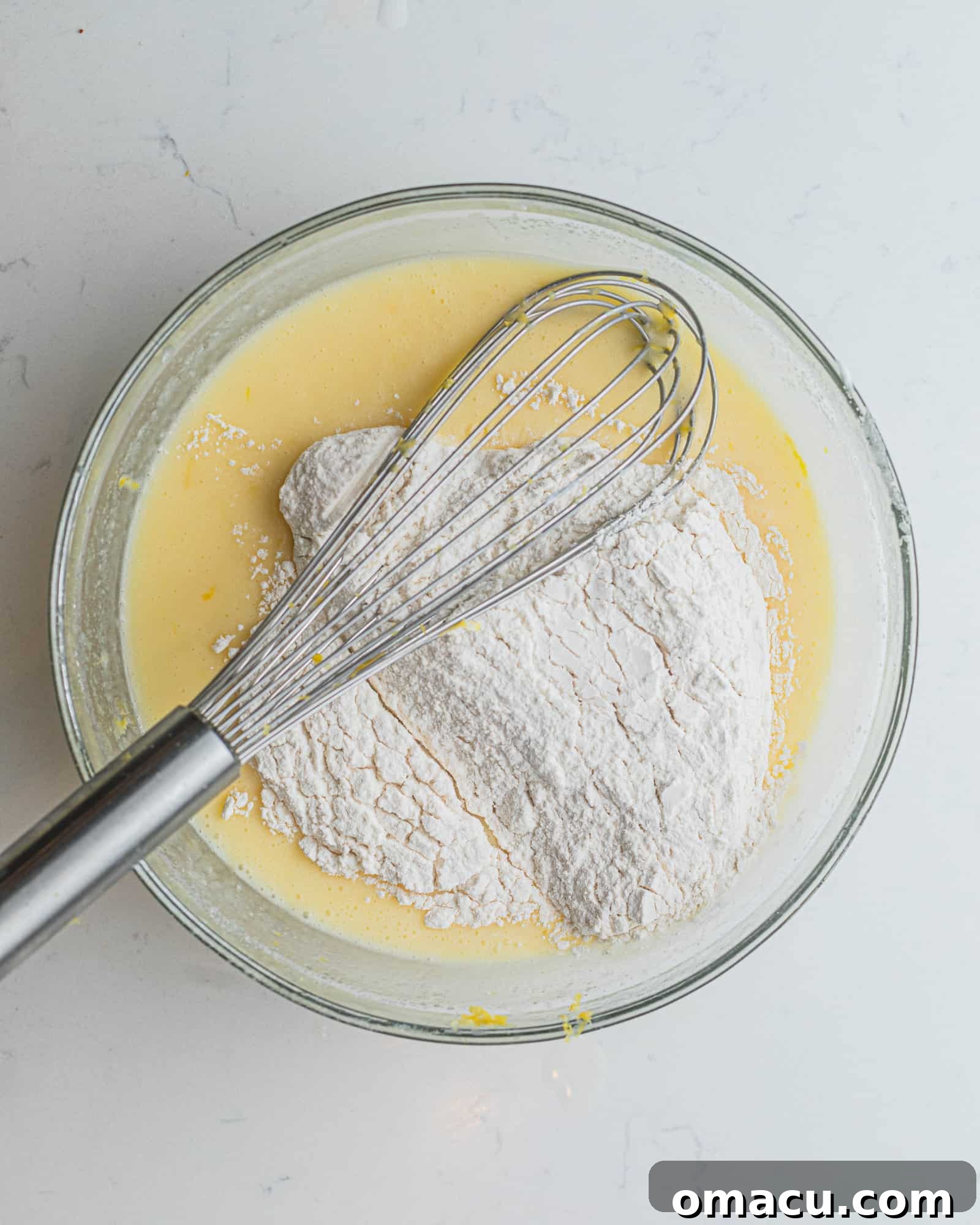 wet ingredients and dry ingredients mixed together in a large mixing bowl