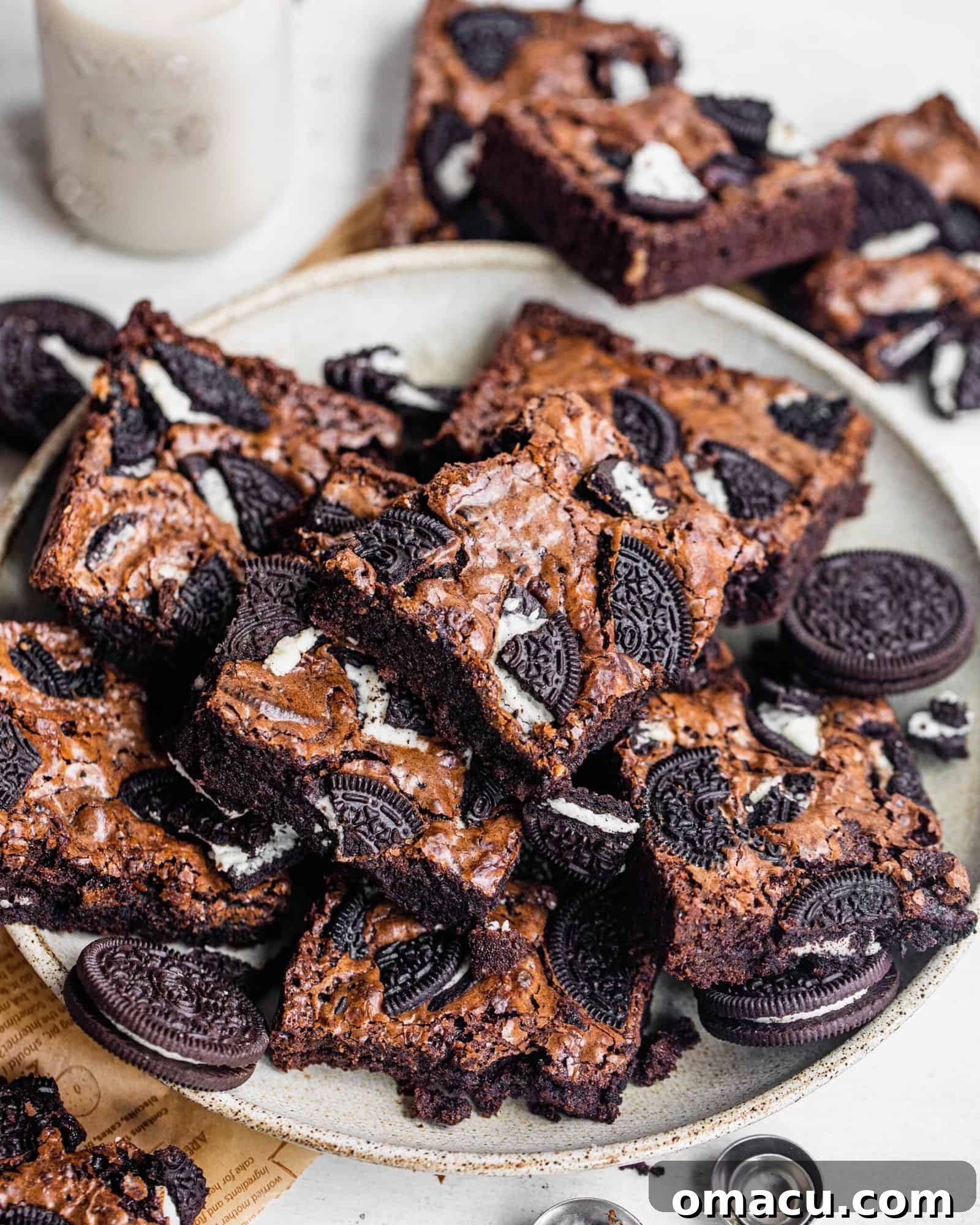 A delicious array of baked goods presented on a plate, with a refreshing glass of milk in the background, inviting a moment of sweet indulgence.