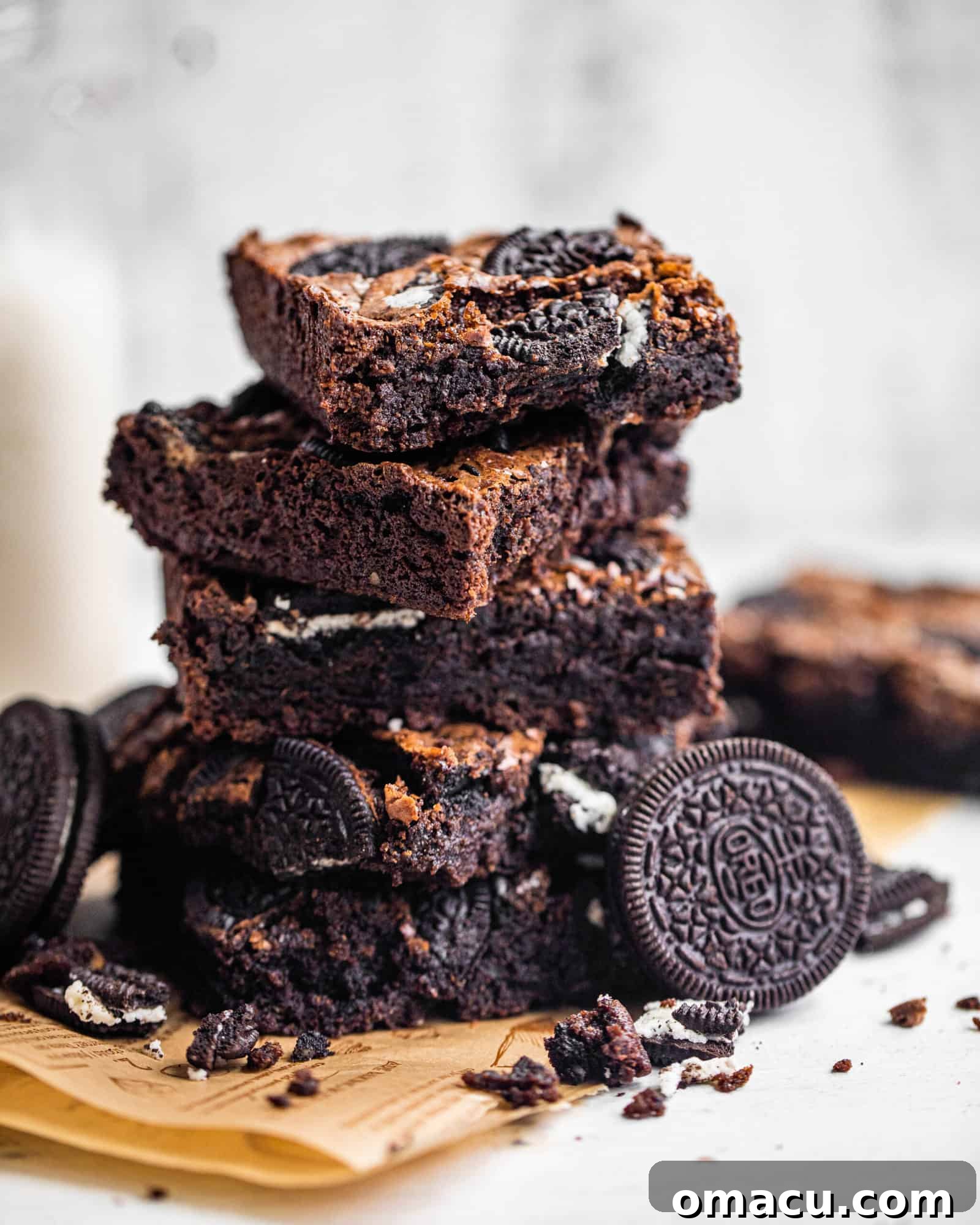 Close-up shot of the rich, fudgy texture of an Oreo brownie, emphasizing its deep chocolate color and visible cookie pieces.