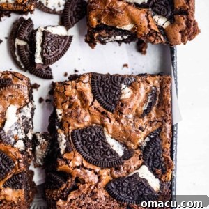 An Oreo brownie cut into a square on a baking sheet, showcasing its perfect texture.