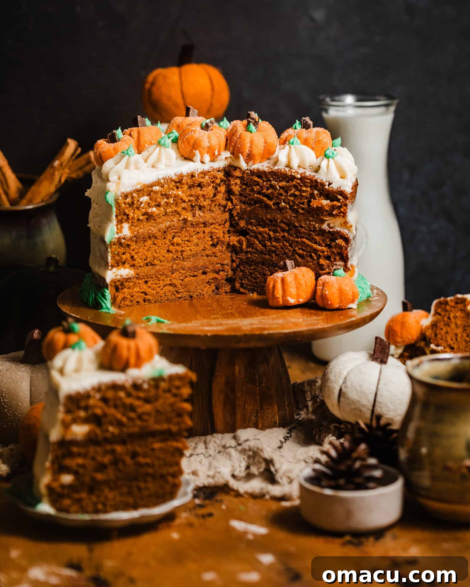 Close-up of a slice of moist brown butter pumpkin cake, revealing the delicious maple pumpkin butter filling and rich cream cheese frosting.