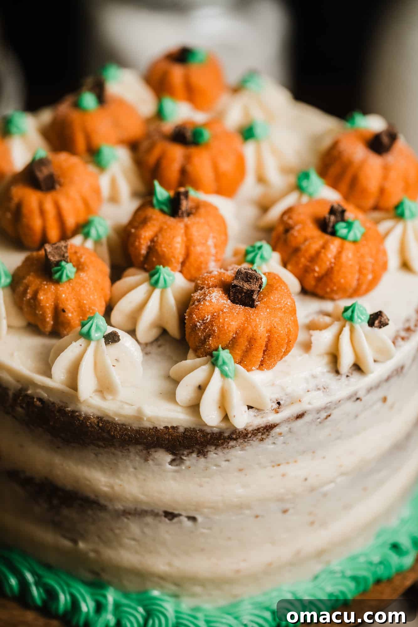 A baker preparing the pumpkin cake batter in a mixing bowl, showcasing the vibrant orange color of the pumpkin puree.