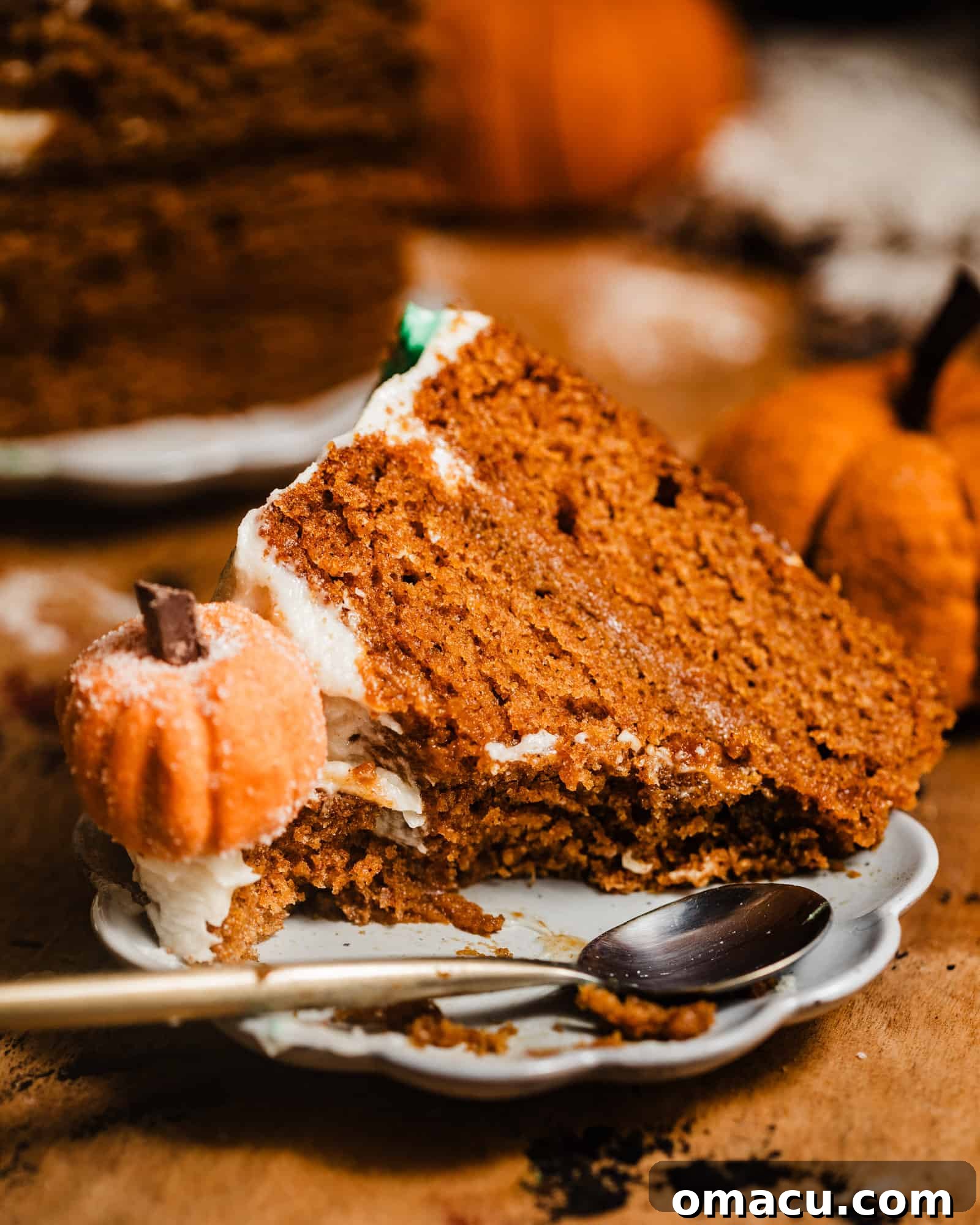 A freshly baked and frosted brown butter pumpkin cake, ready for slicing, highlighting its perfect layers.
