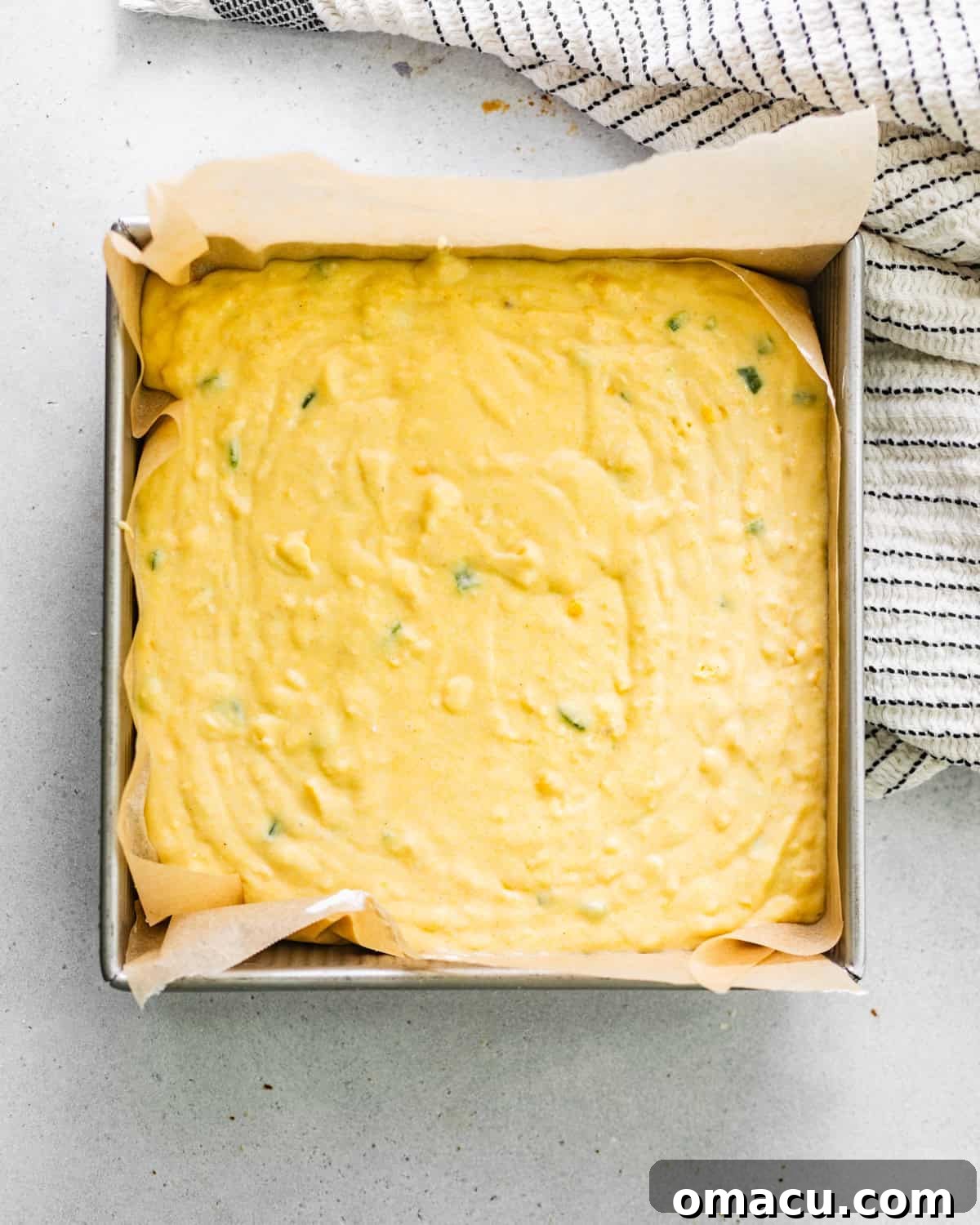 cornbread batter in square baking dish.