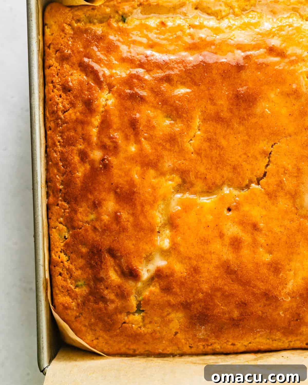 up close photo of finished cornbread with honey butter brushed on top. 